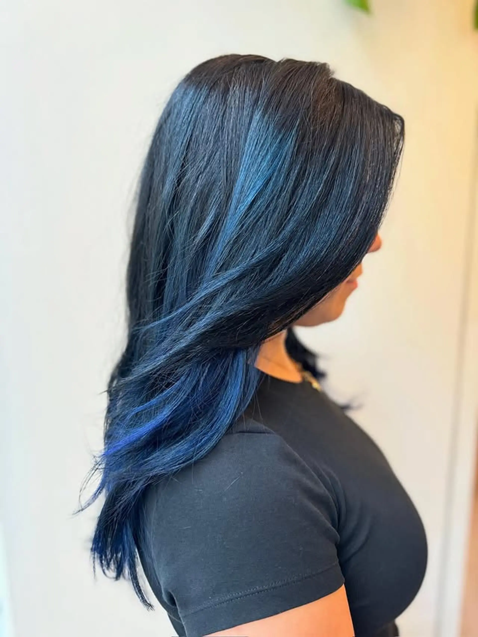 Long layered hairstyle with vibrant blue highlights. 1