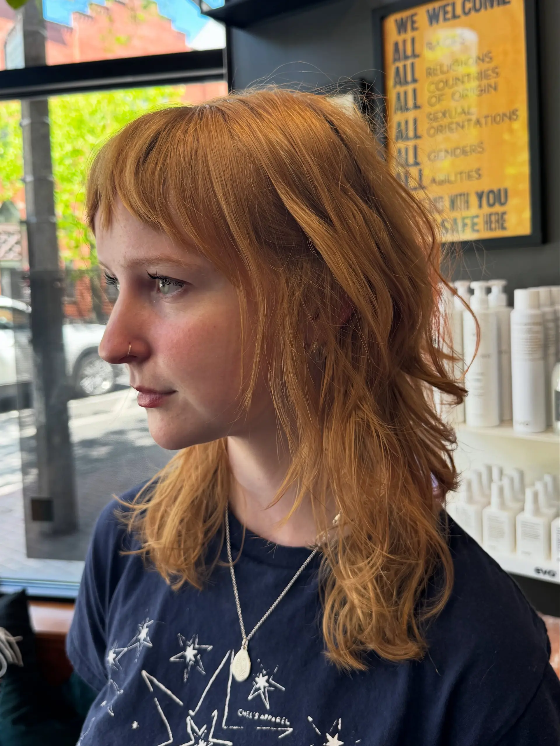 A textured mid-length shag featuring piecey micro bangs and wavy, layered copper locks. 1