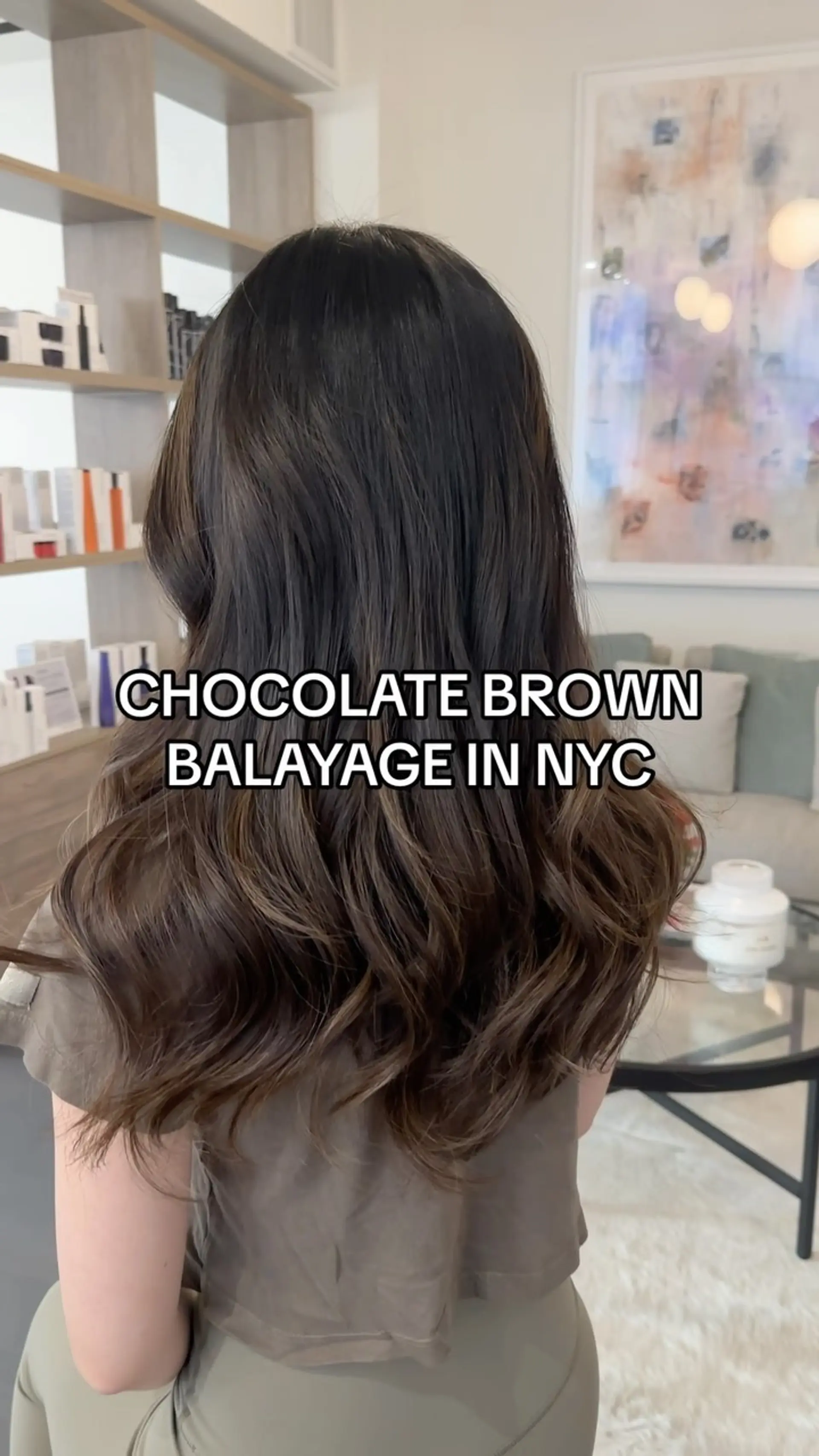 Long chocolate brown hair featuring subtle balayage highlights styled in soft, loose waves. 1