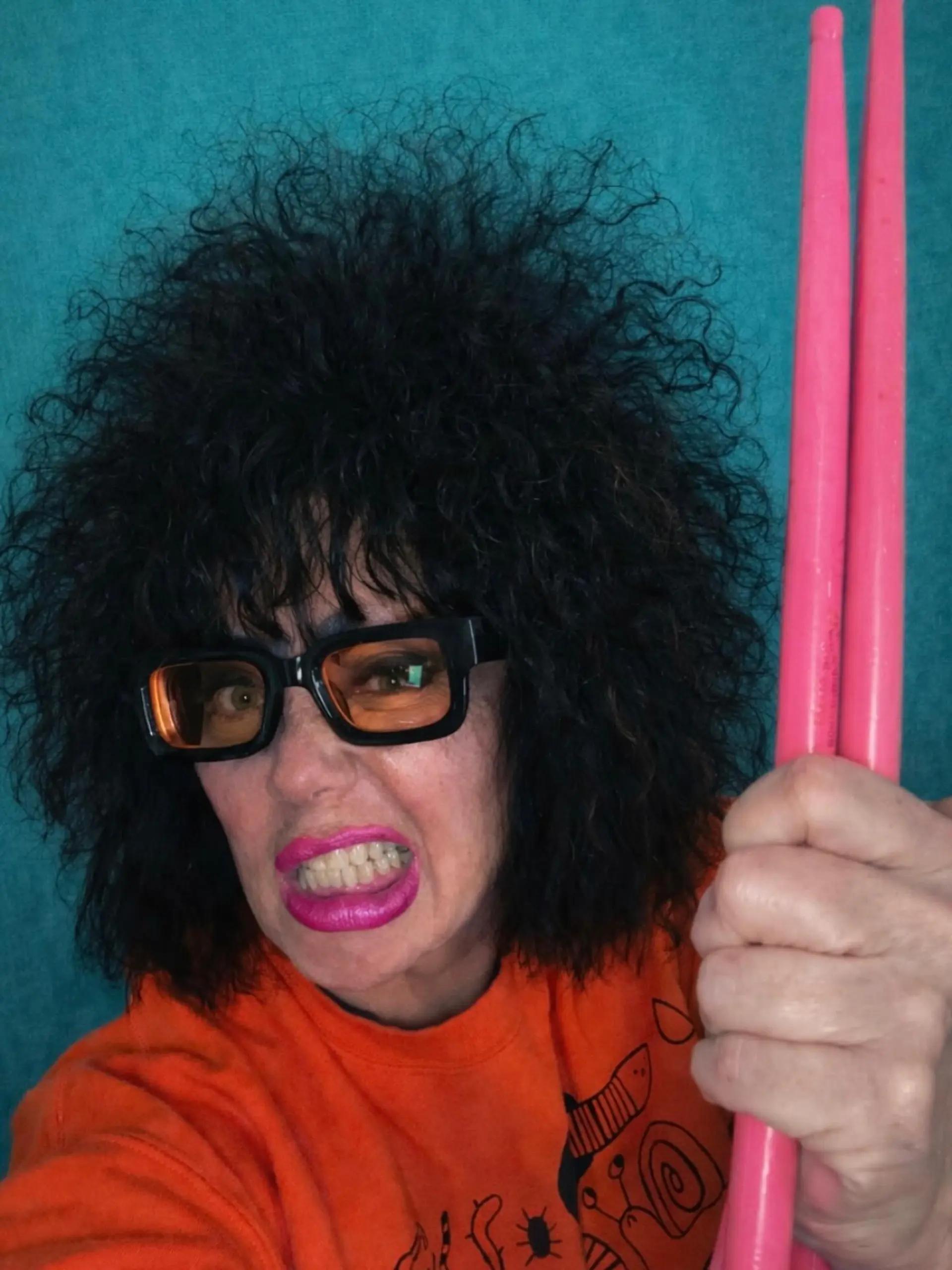 High-volume teased curly black hair styled with textured front bangs. 1