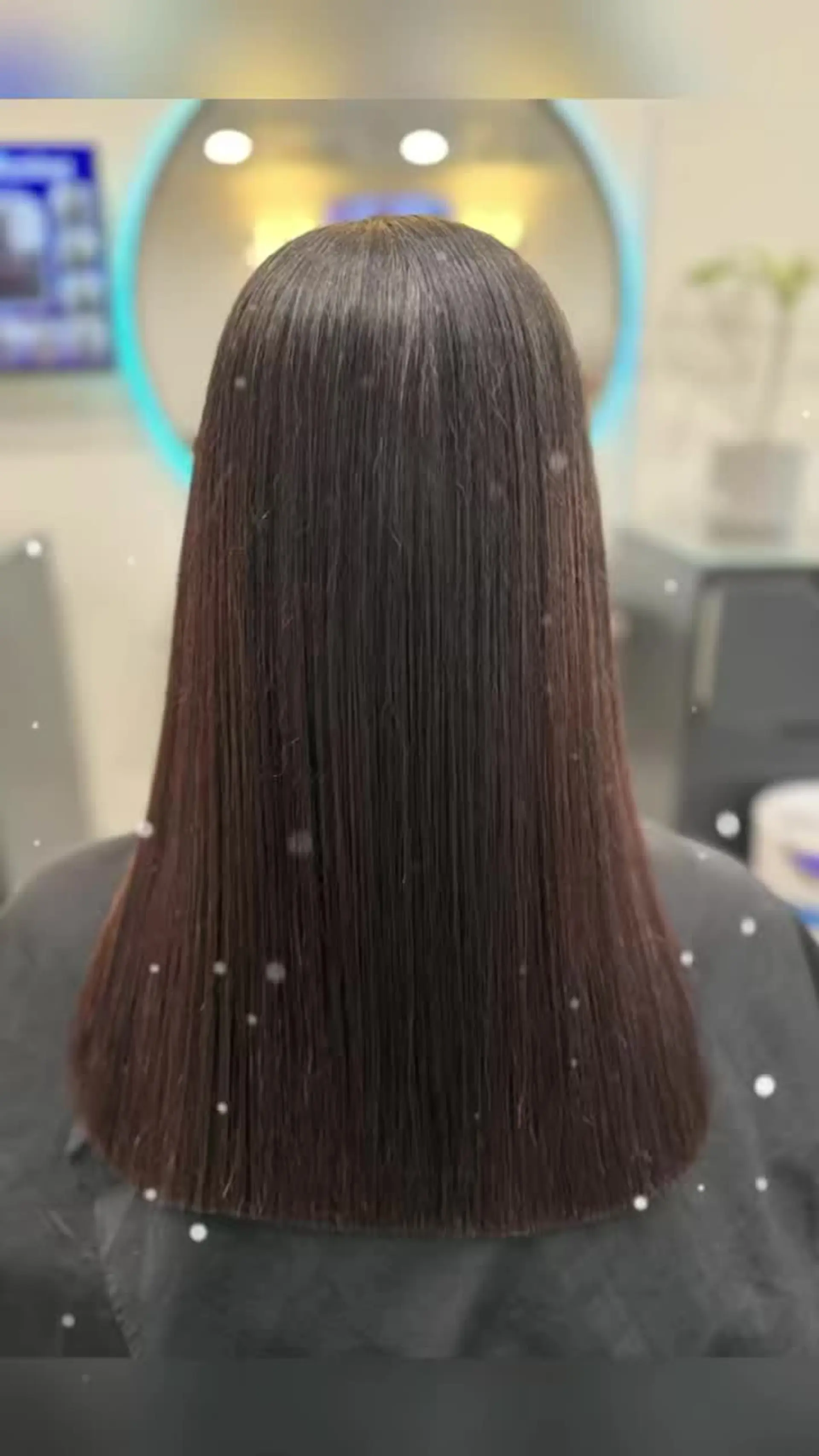 A glossy, ultra-sleek medium-length lob styled pin-straight with a clean, blunt perimeter. 1