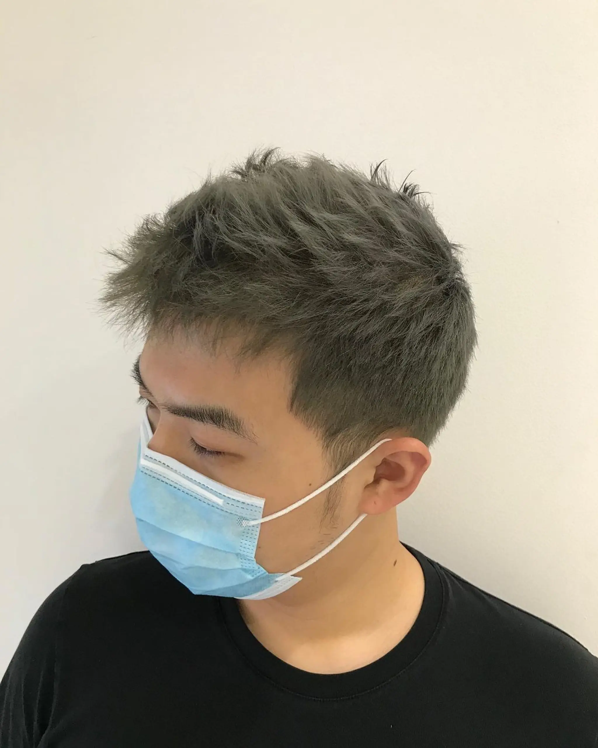 Short, straight gray hair with a textured quiff on top and tapered sides.