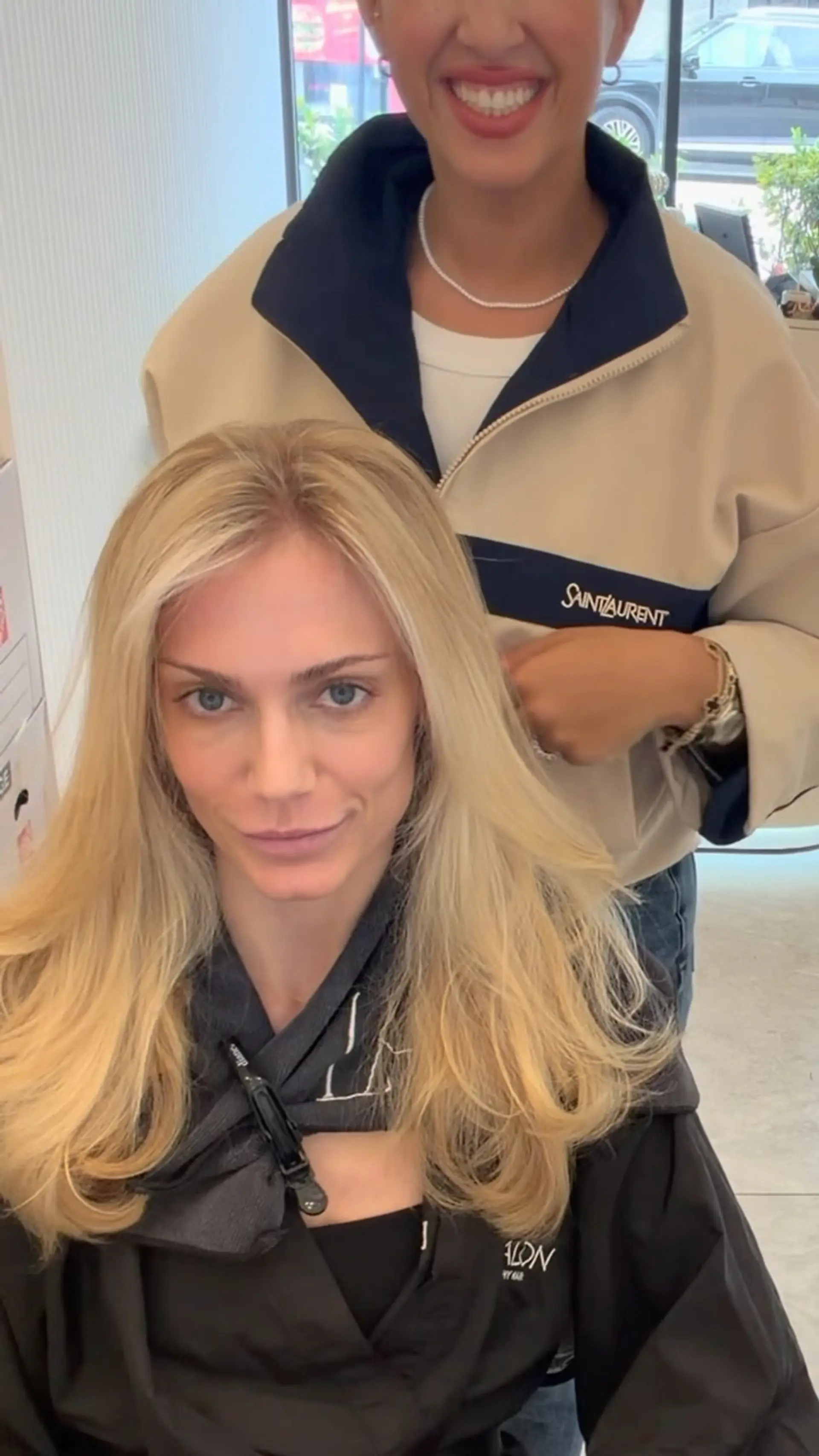Long, flowing blonde hair styled with a center part and a voluminous blowout featuring softly curled ends. 1
