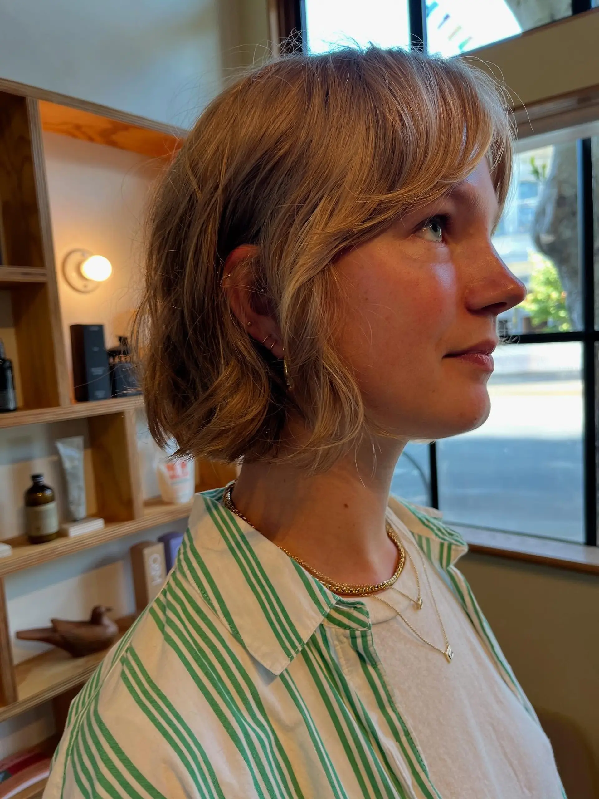 A textured short bob with light undone waves and soft, wispy bangs. 1