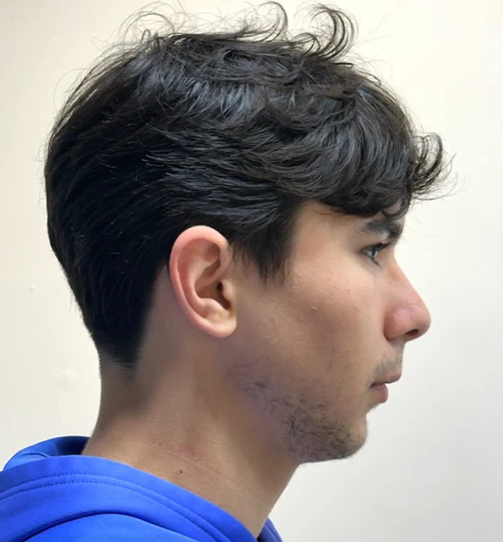 Short, wavy dark brown hair with a natural, textured look, softly tousled with layers for enhanced volume. 1