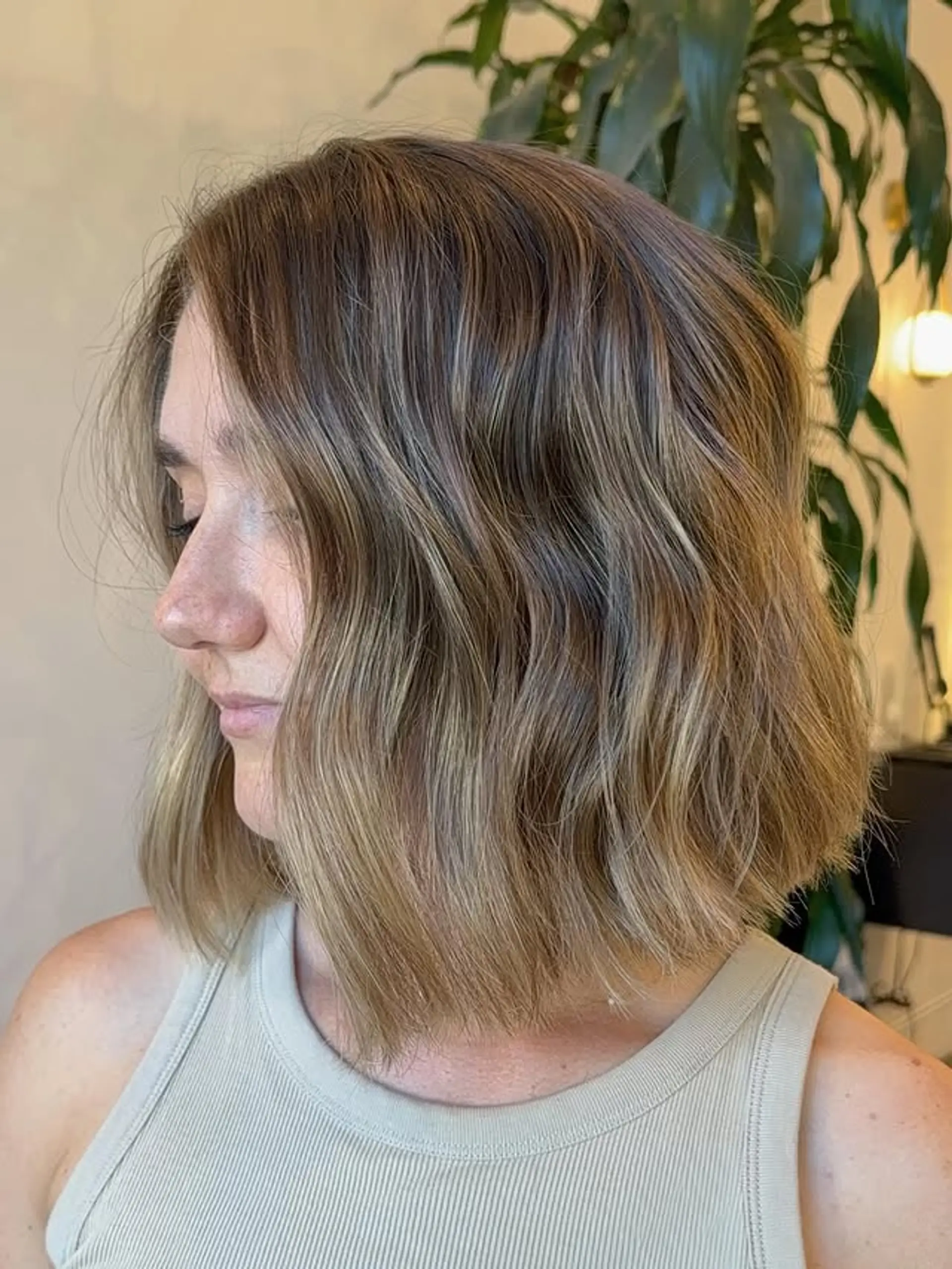 A medium-length wavy bob with a bronde balayage and beachy waves. 1