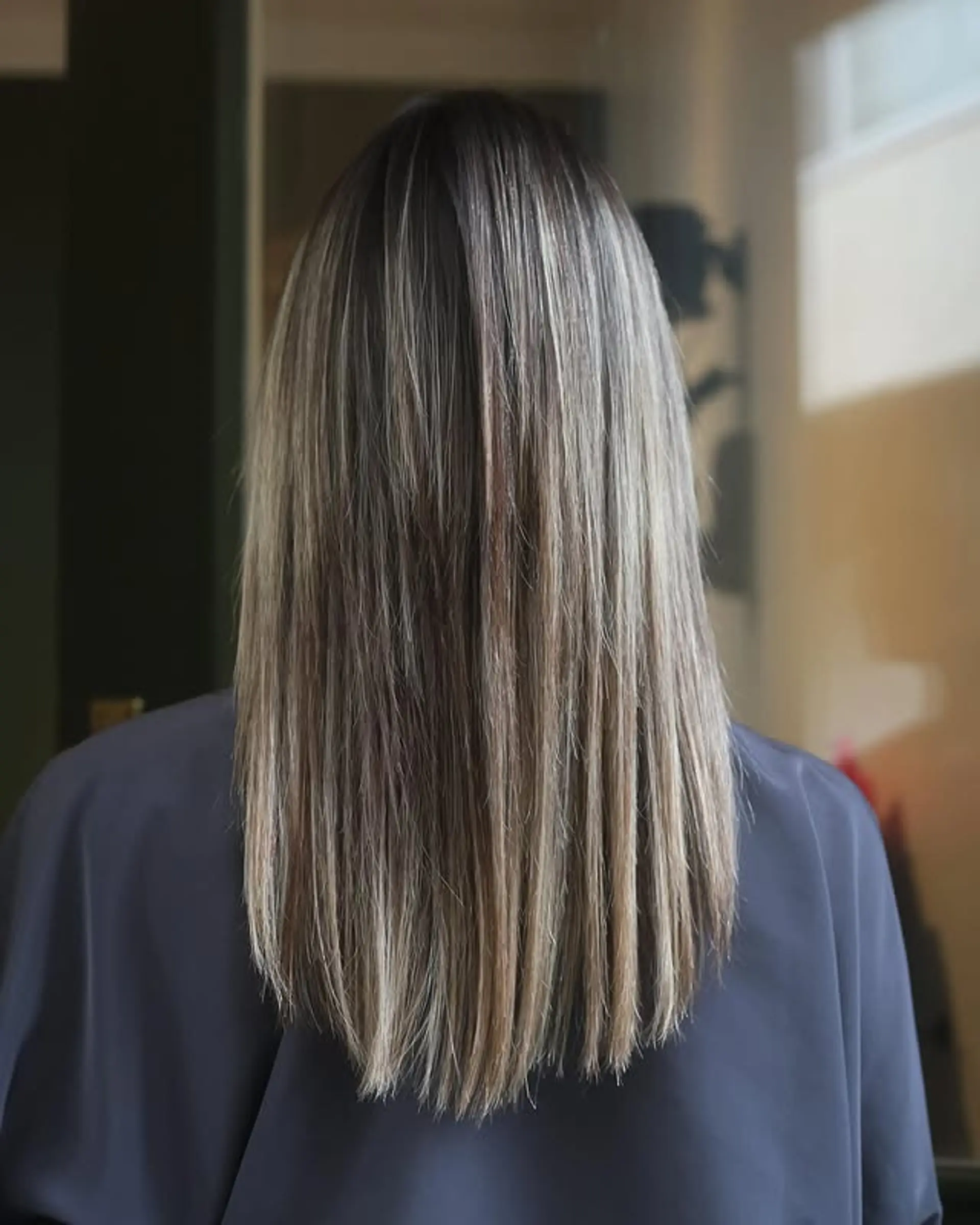 A trendy medium-length lob with a blonde balayage. 1