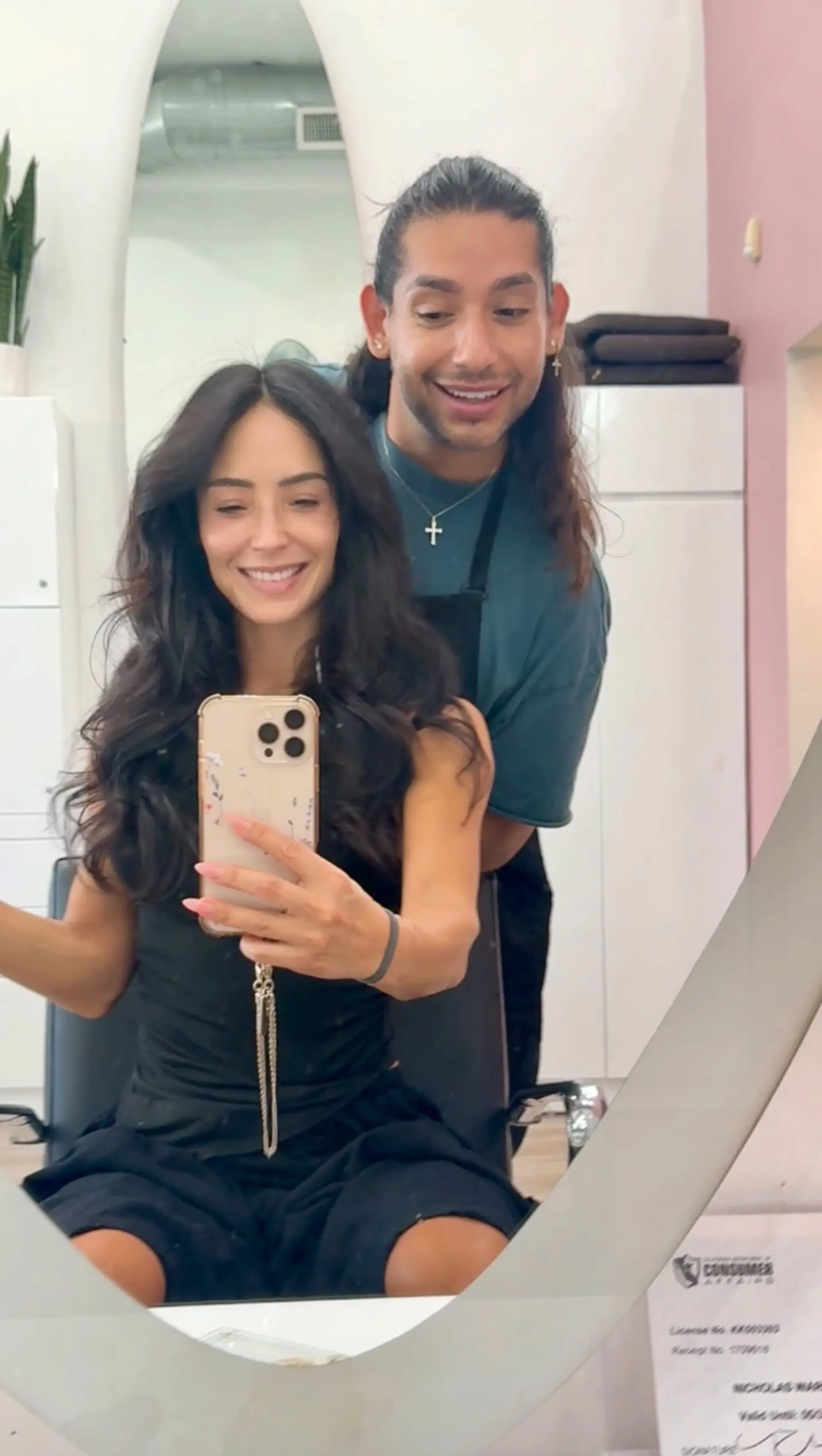 Long dark hair styled into a bouncy, voluminous blowout with soft waves. 1