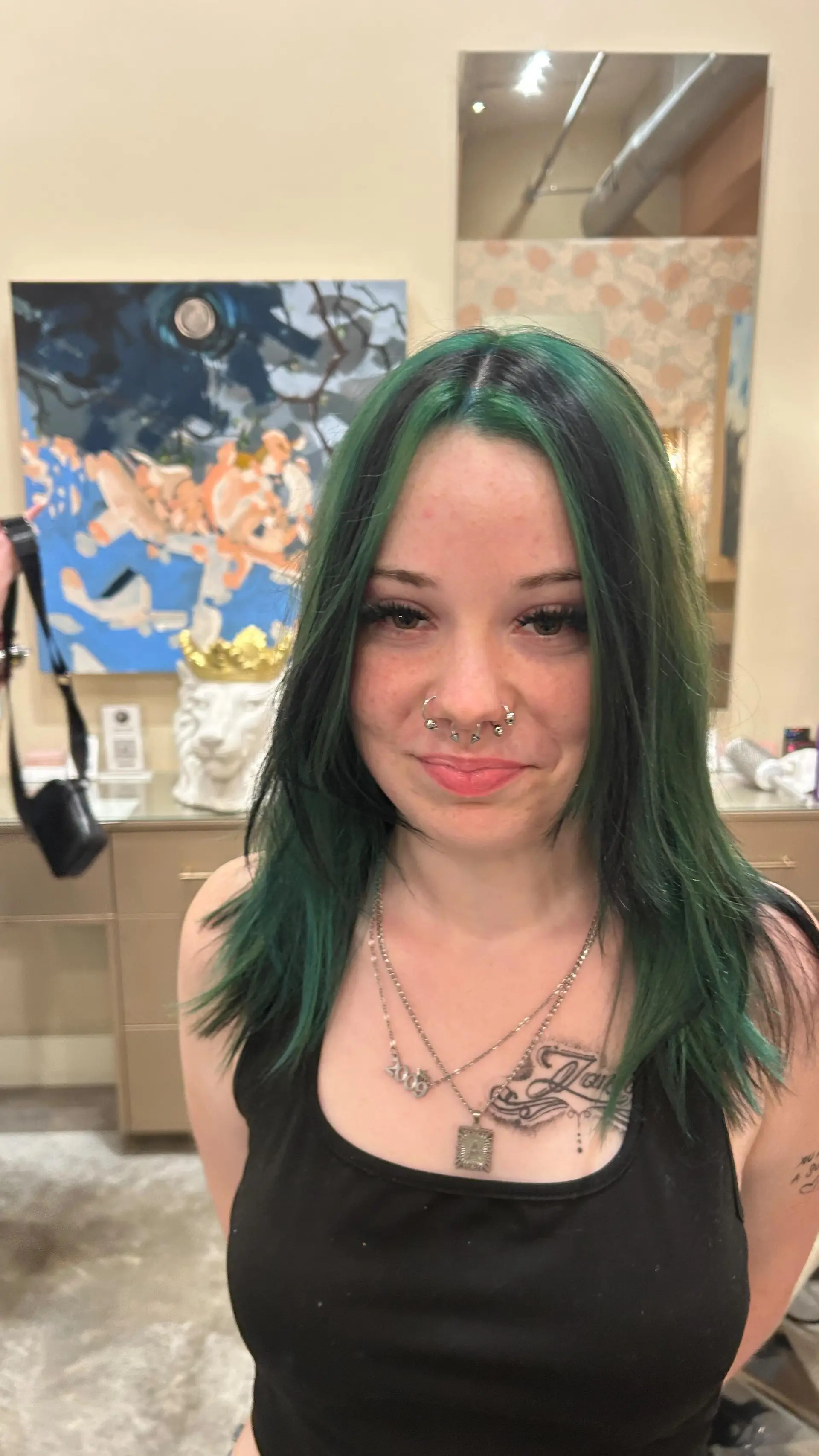 Medium-length textured straight cut featuring bold dark green and black color blocking with a center part. 1