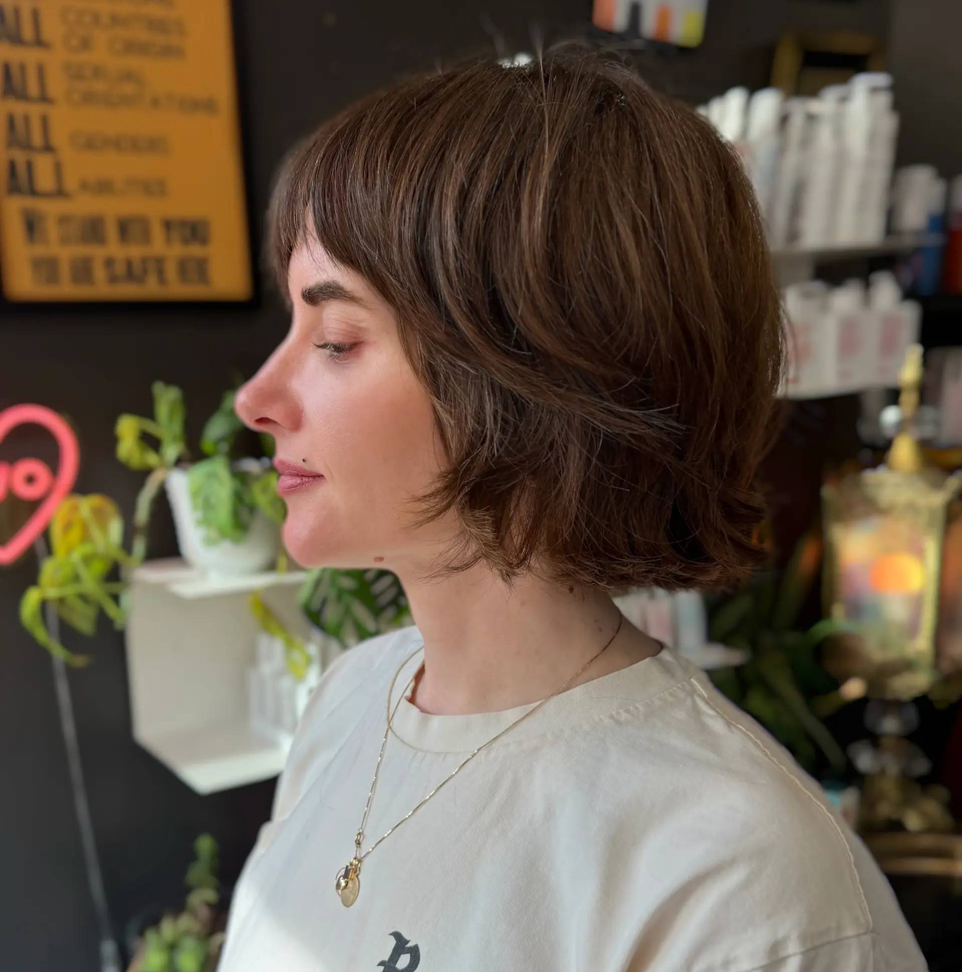 A textured chin-length French bob featuring wispy, brow-skimming bangs and soft, lived-in layers that create natural movement. 1