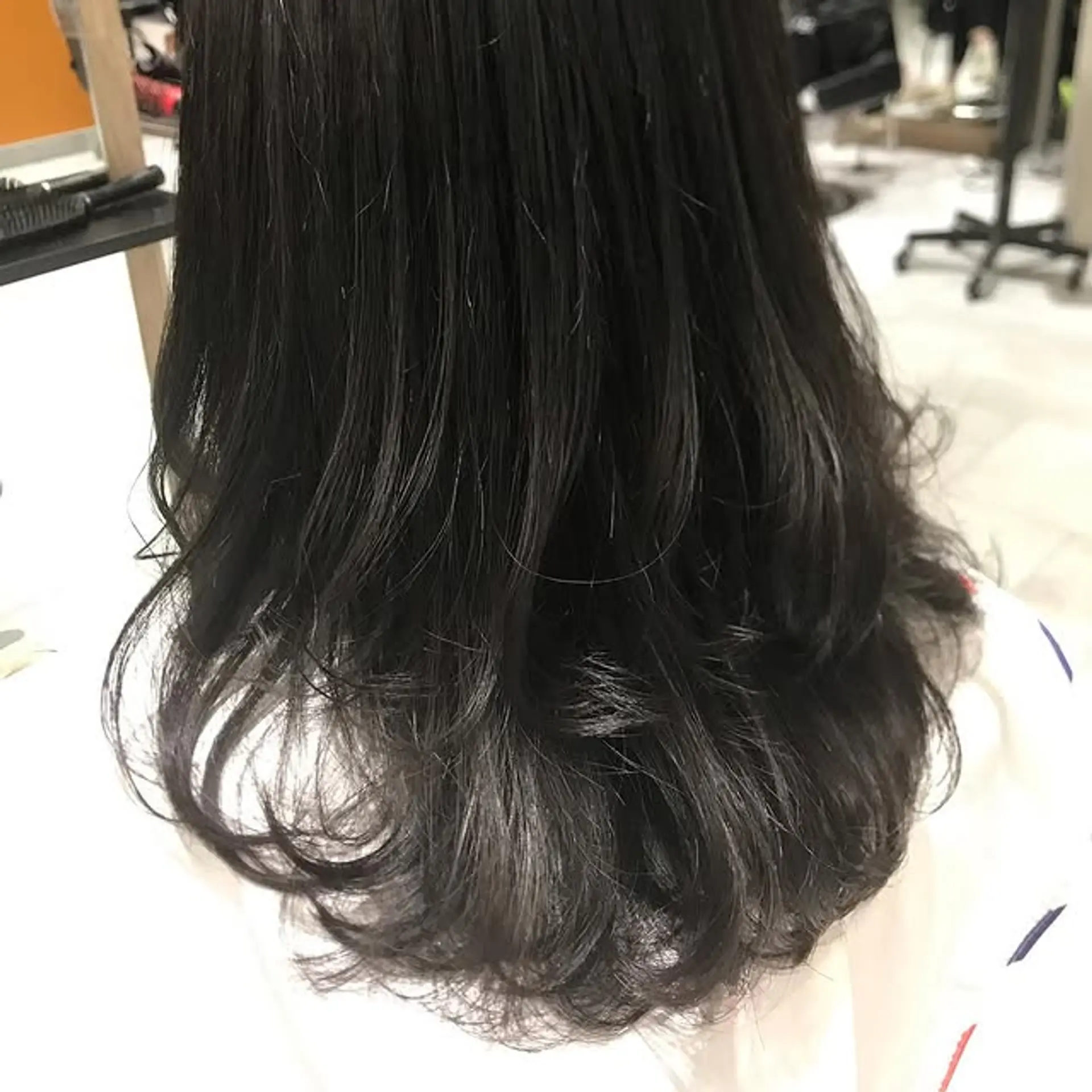 A layered lob with a subtle ombre, featuring a shadow root and lighter ends. 1