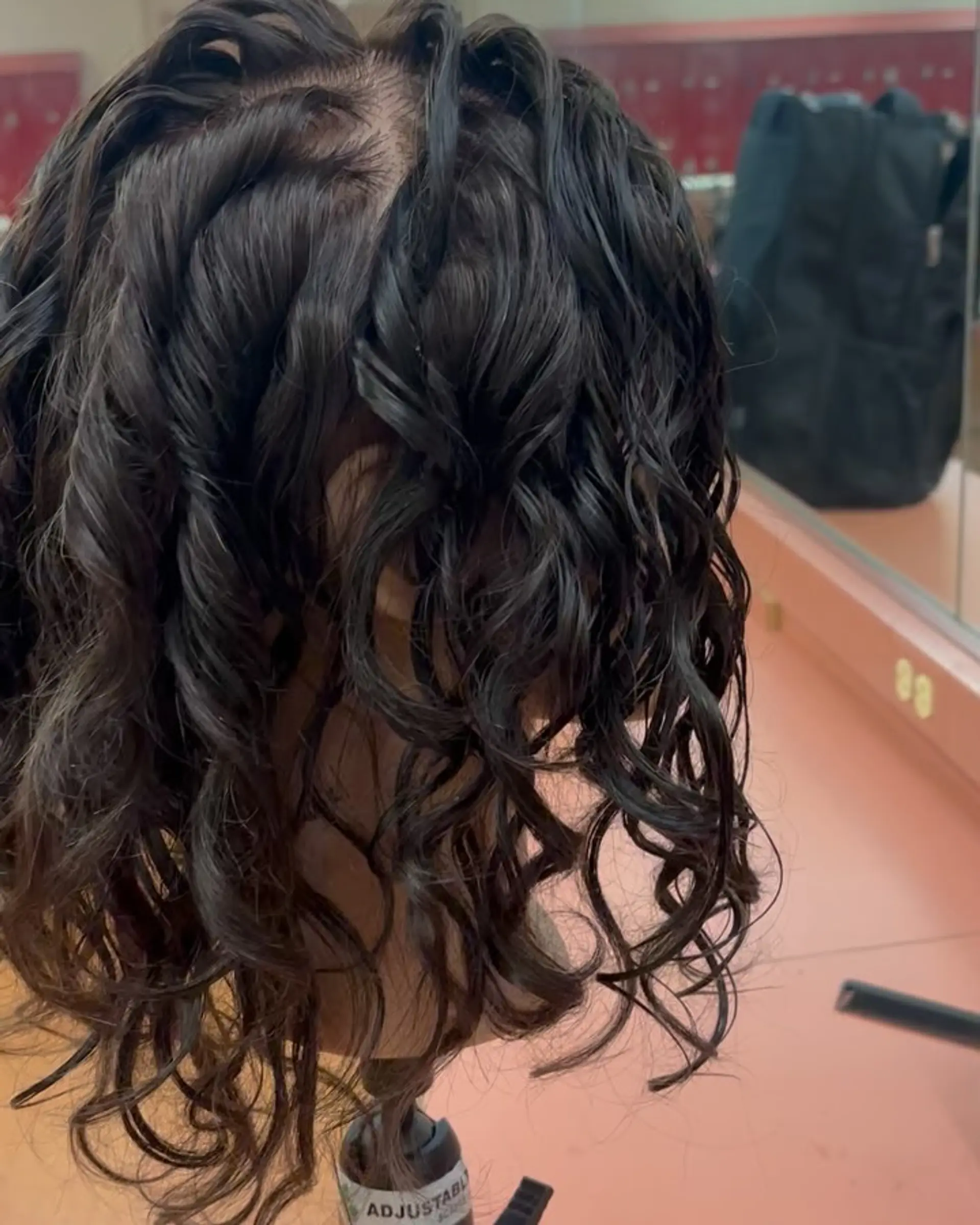 Defined, glossy spiral curls showcasing freshly processed water perm texture on shoulder-length dark hair. 1