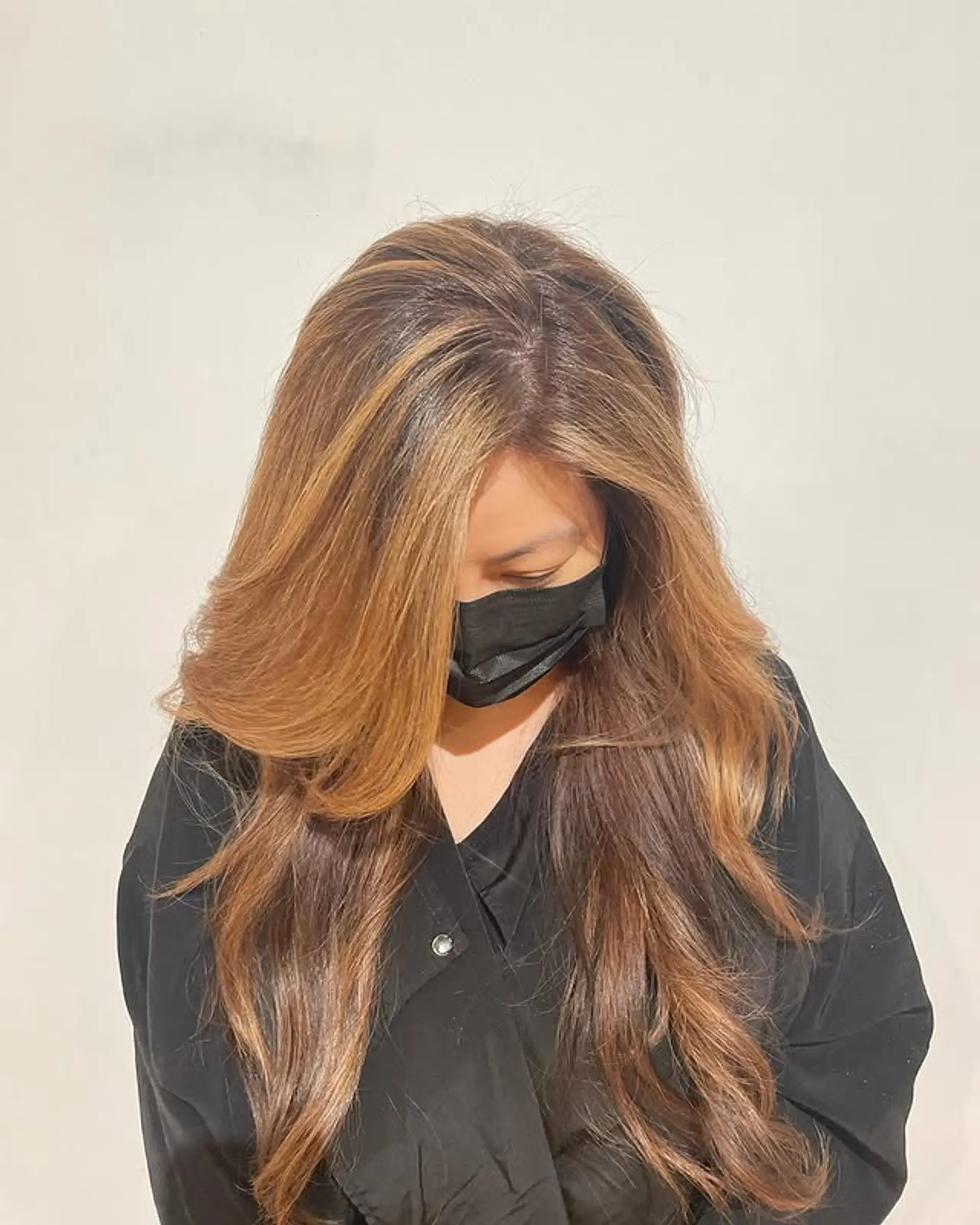 Long layered cut with caramel balayage highlights. 1