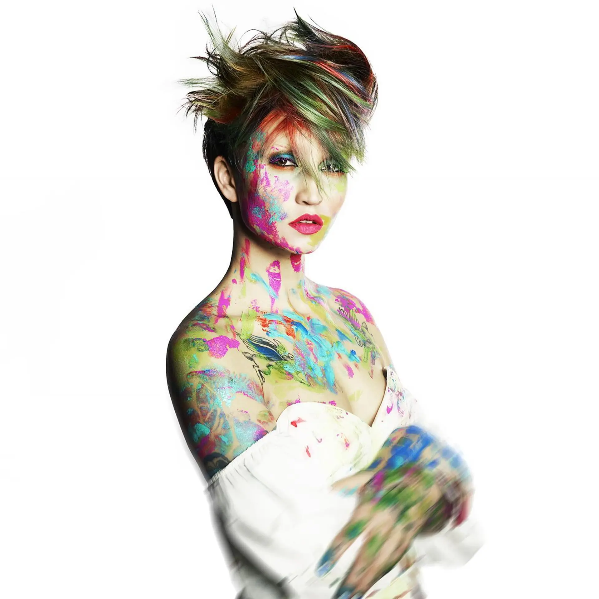 A bold, spiky pixie cut styled with high texture and colorful green, red, and yellow highlights throughout the fringe and crown. 1