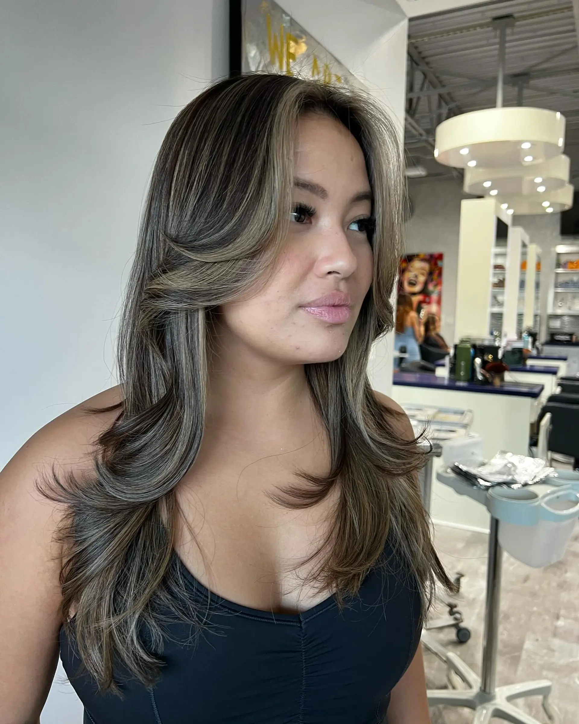 A long layered cut with face-framing layers and 70s-inspired curtain bangs. 1