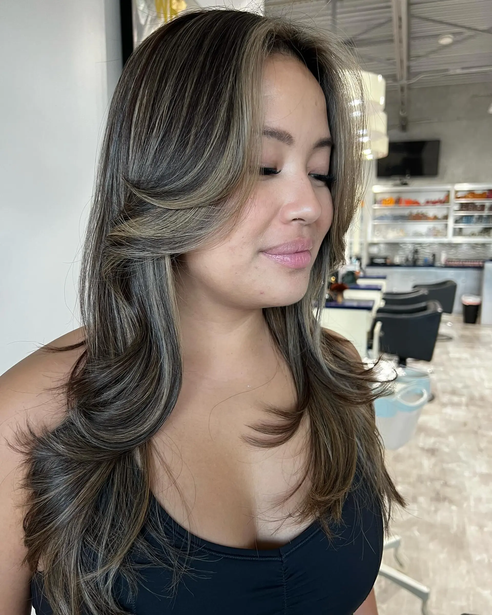 A long layered cut with face-framing layers and 70s-inspired curtain bangs. 3