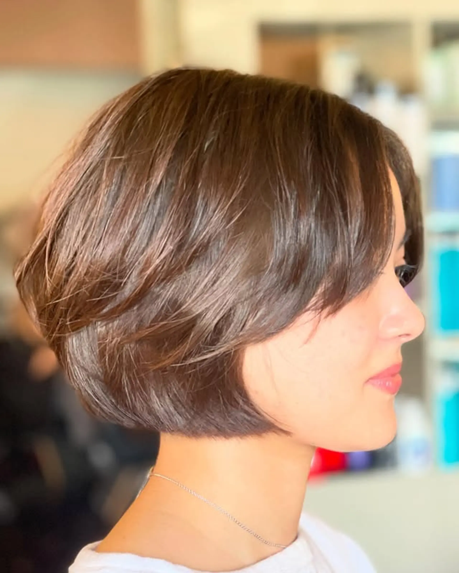 A short, layered bob with soft curtain bangs. 1