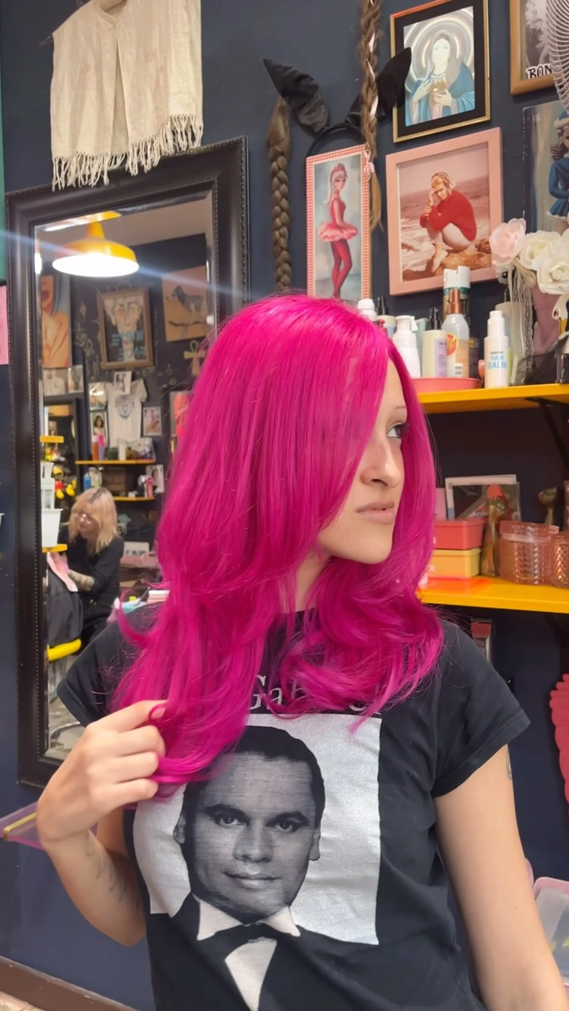 Vibrant electric hot pink hair cut with long sweeping layers and finished with a voluminous blowout. 1