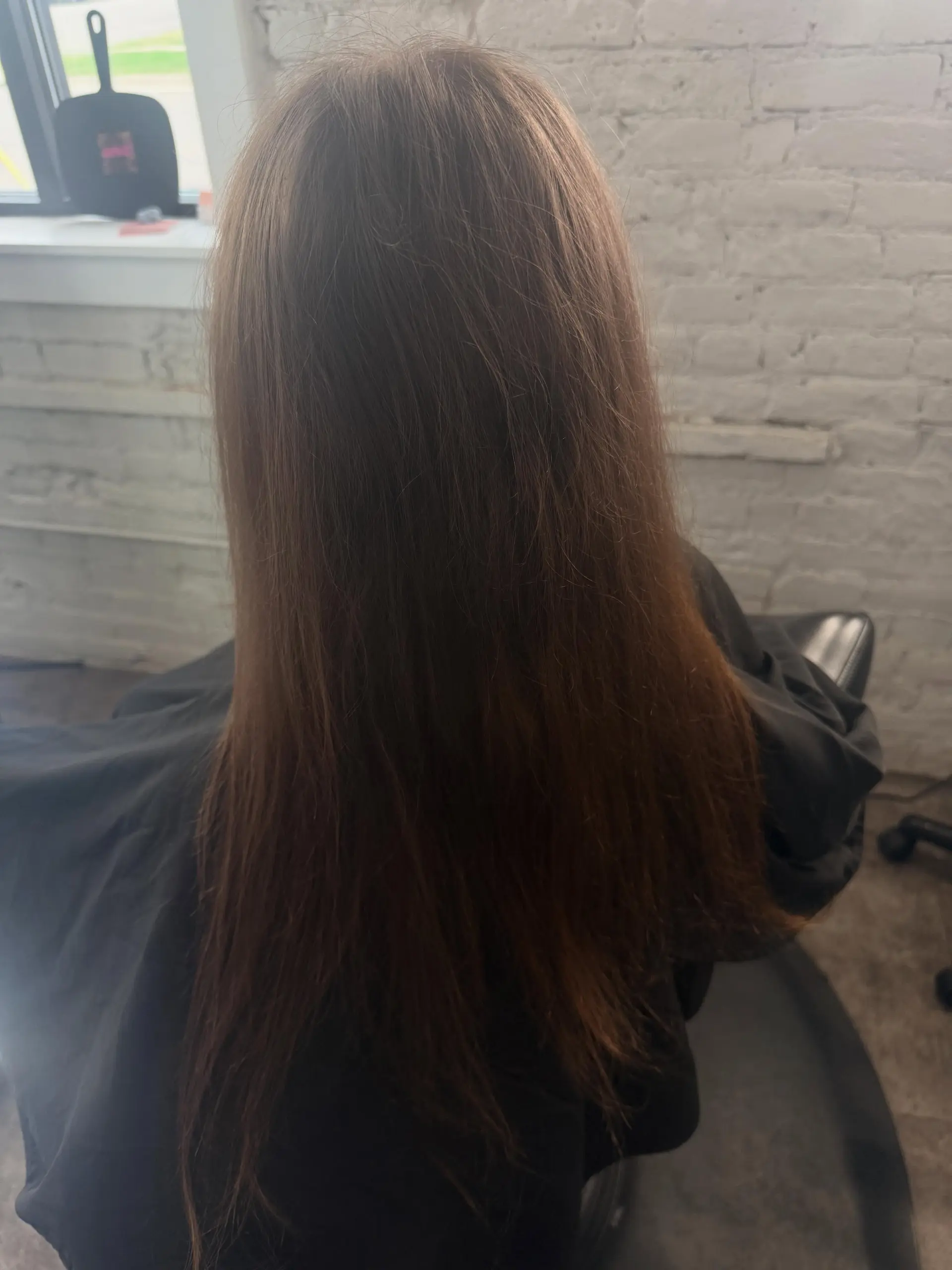 Long, straight brunette hair featuring soft, subtle natural highlights. 1