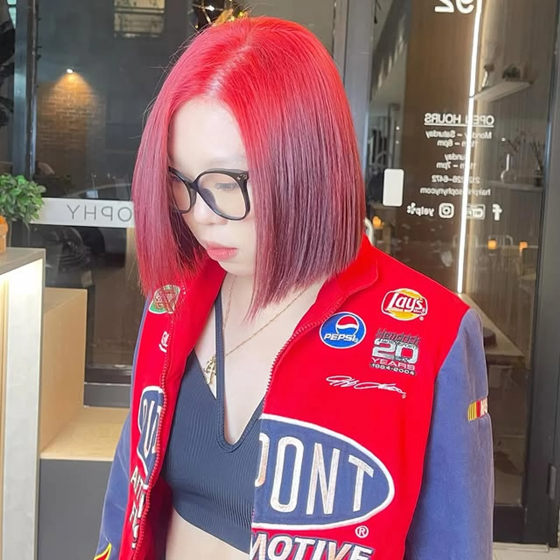 A woman with long, glossy cherry red waves, showcasing the luxurious 'Cherry Lacquer' hair trend of 2026. - Preview 2