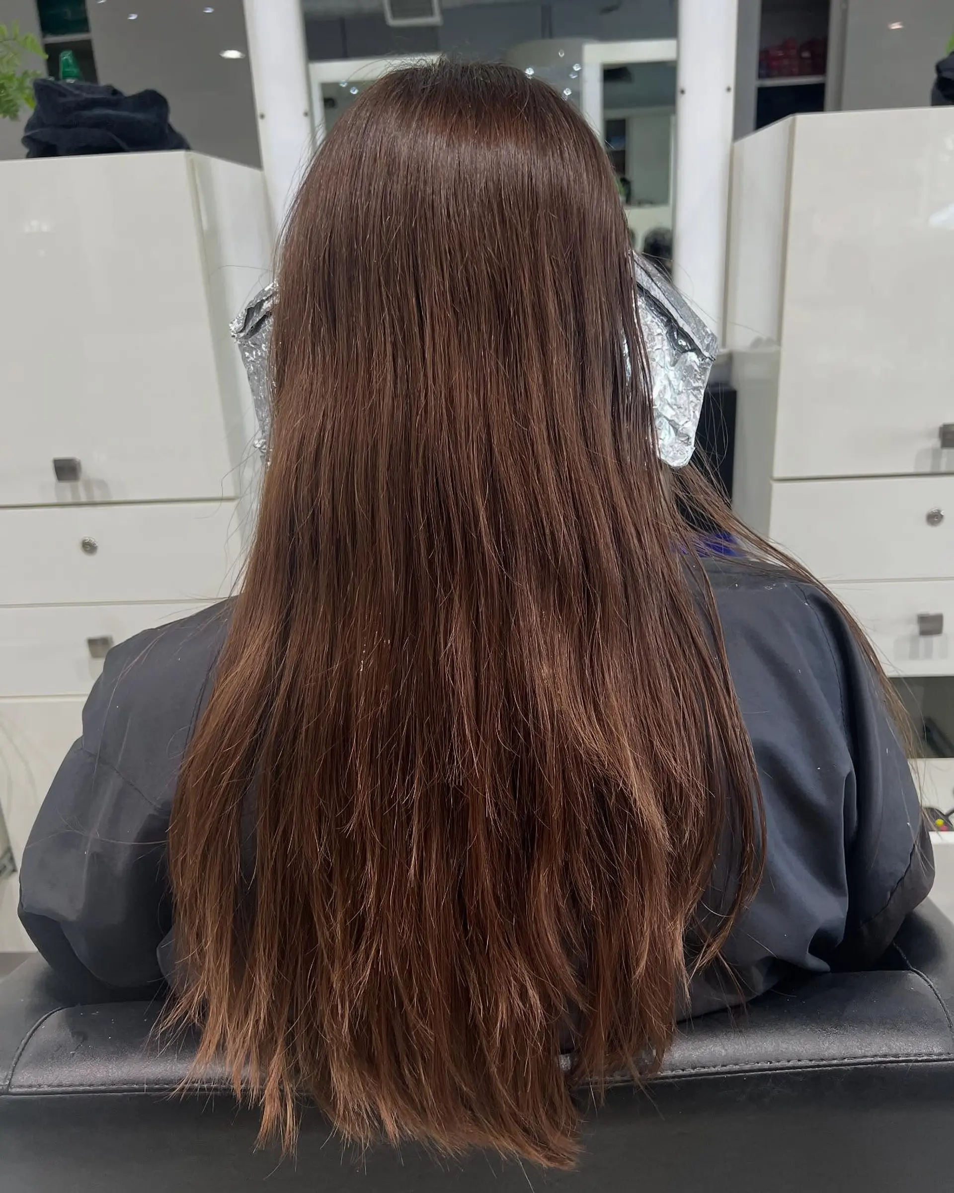 Long layered hairstyle with a bronde color effect and face-framing layers. 4