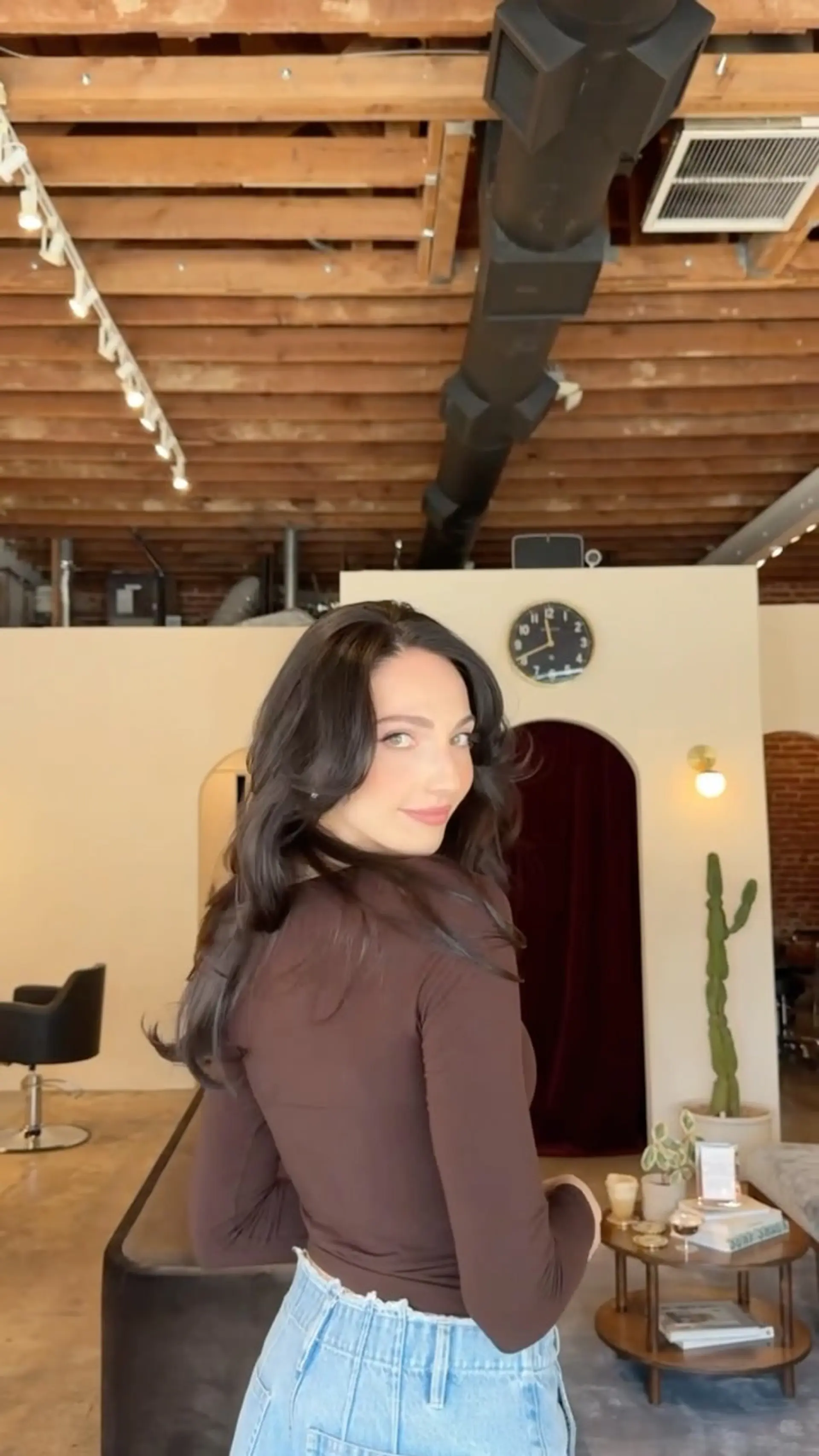 Long dark brown hair styled with soft, voluminous 90s-inspired layers and a bouncy blowout. 1