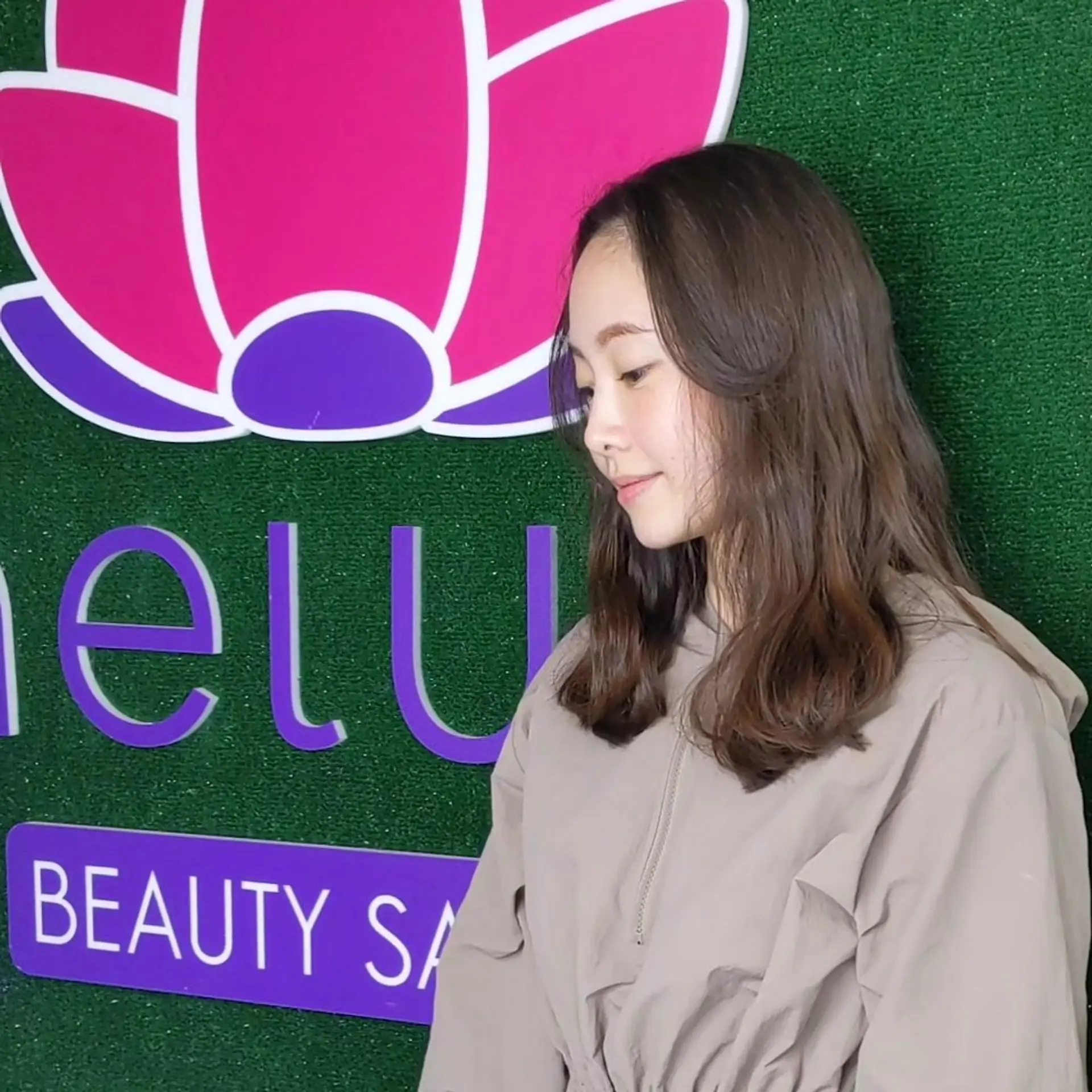 Medium-length layered haircut with soft waves and face-framing fringe in a natural brunette shade. 1