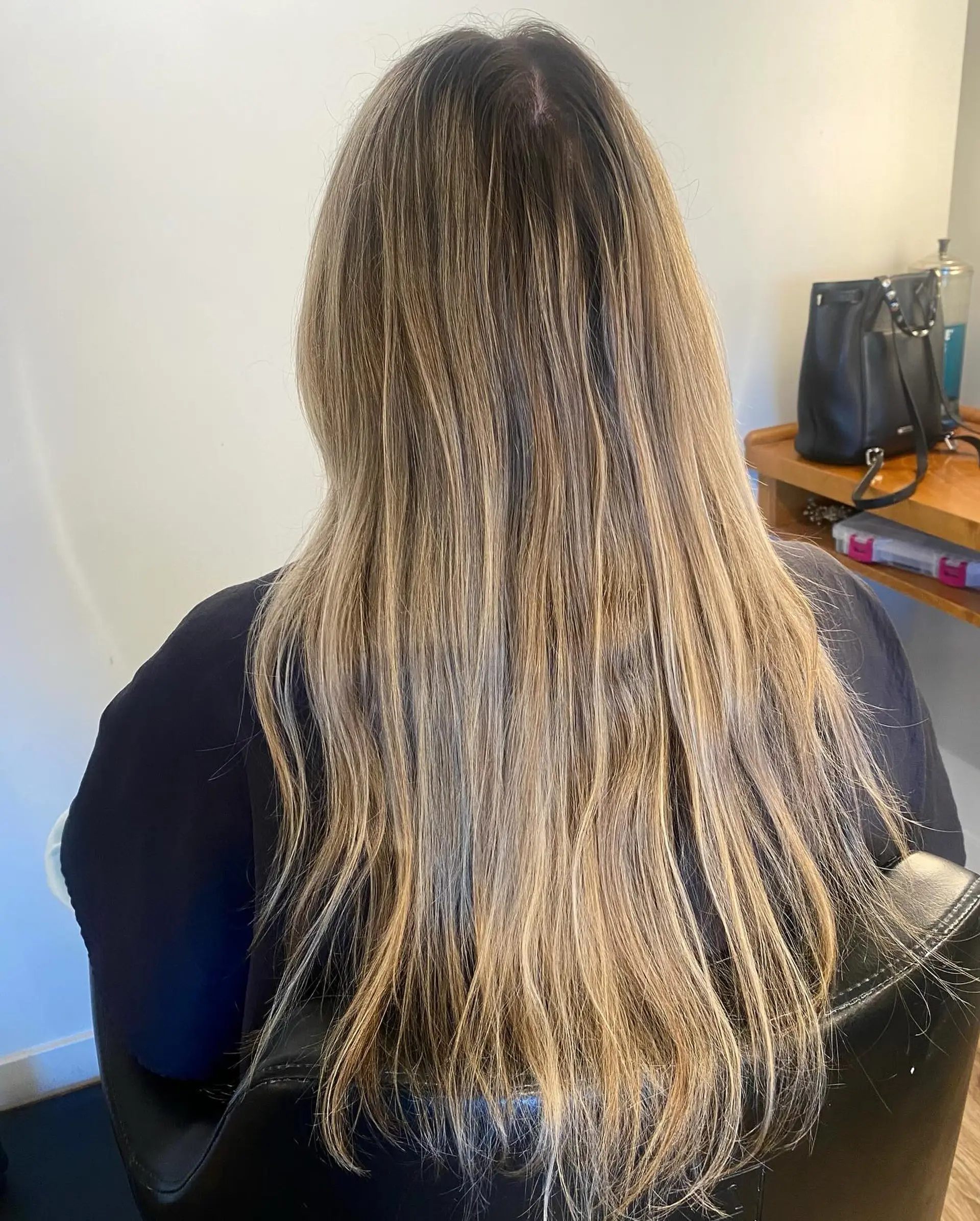 Long straight hair with finely woven blonde highlights over a light brown base. 1