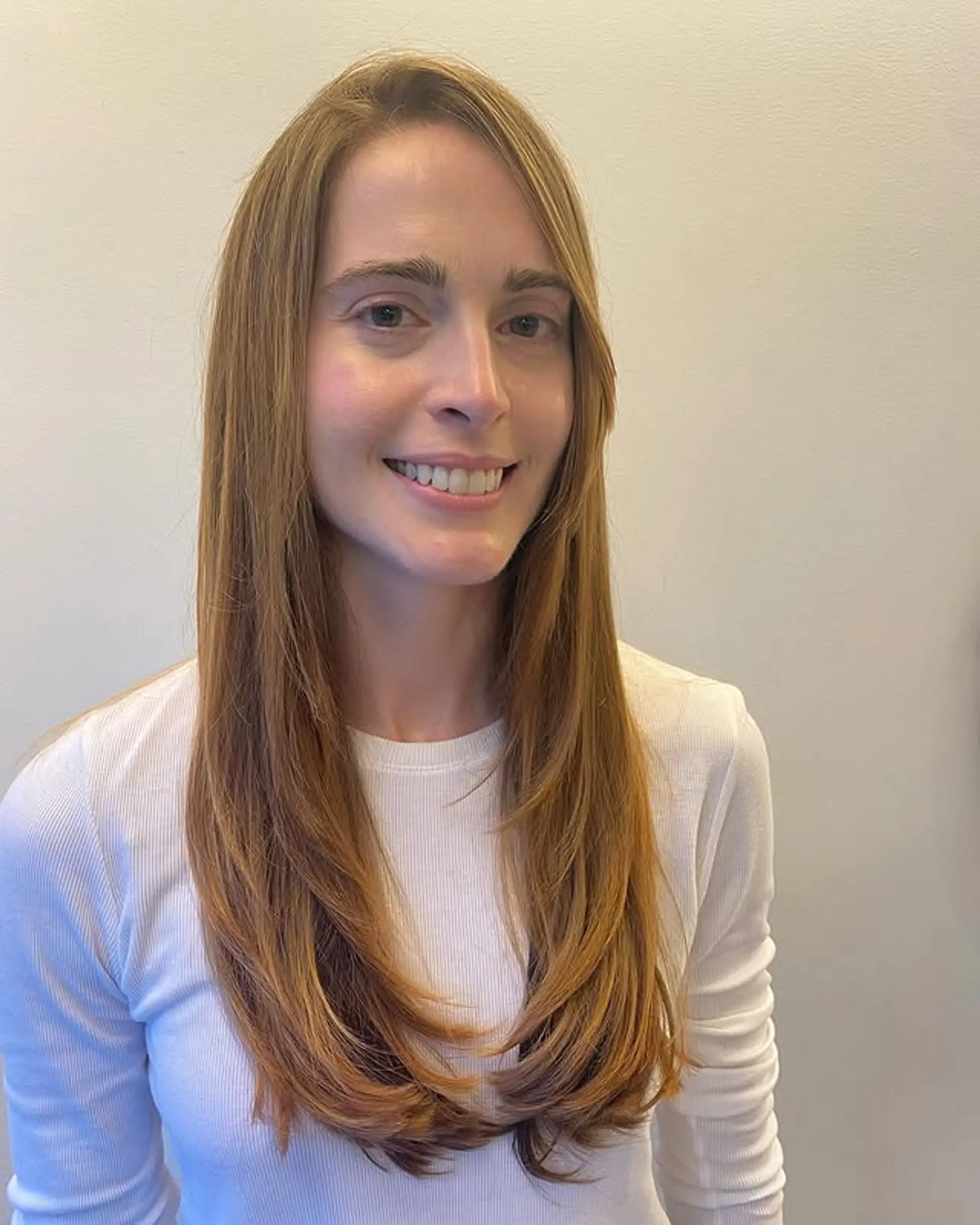 Long layered haircut with face-framing layers. 1