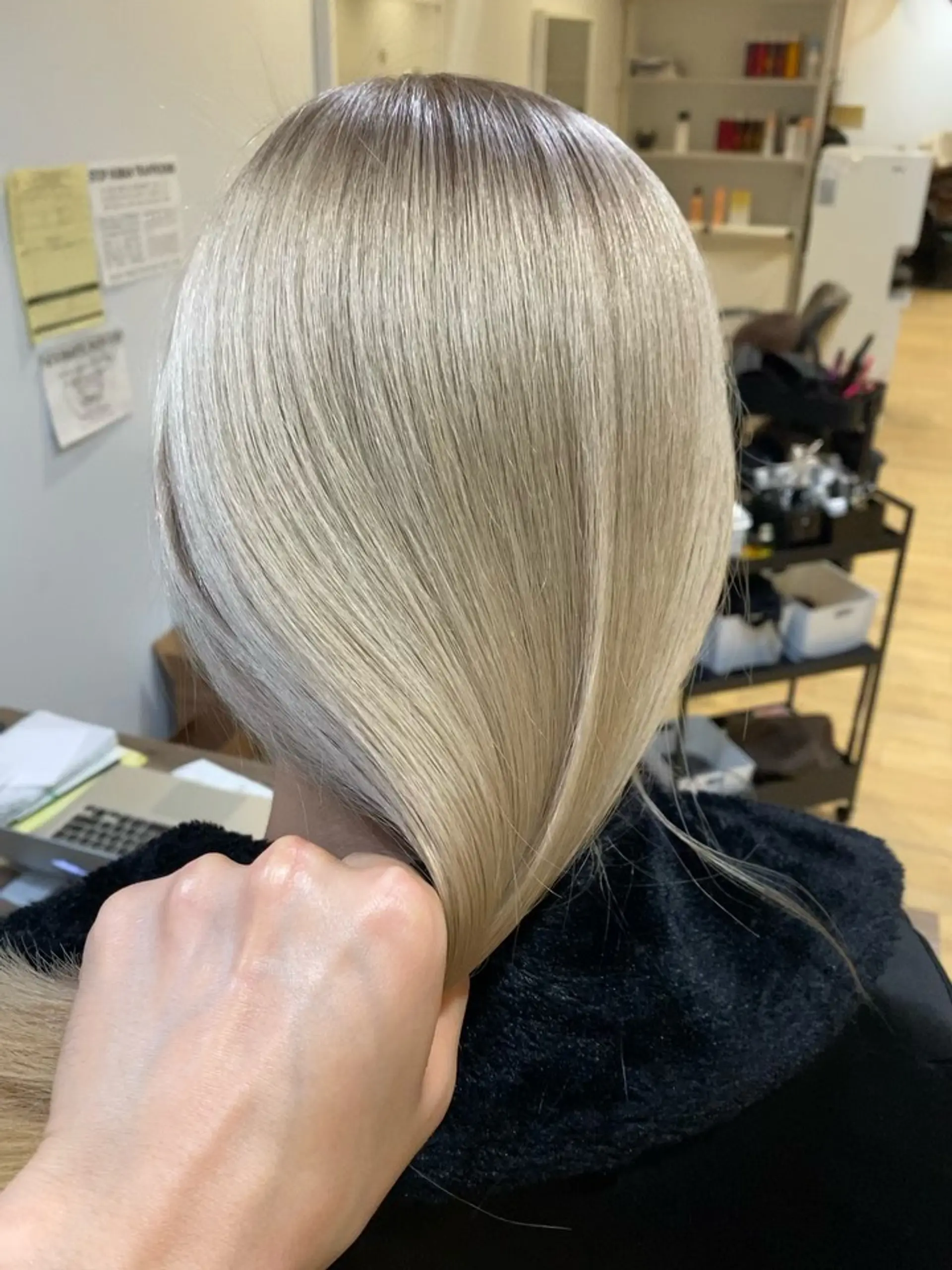 Sleek, straight platinum ash blonde hair with a smooth, glossy finish. 1