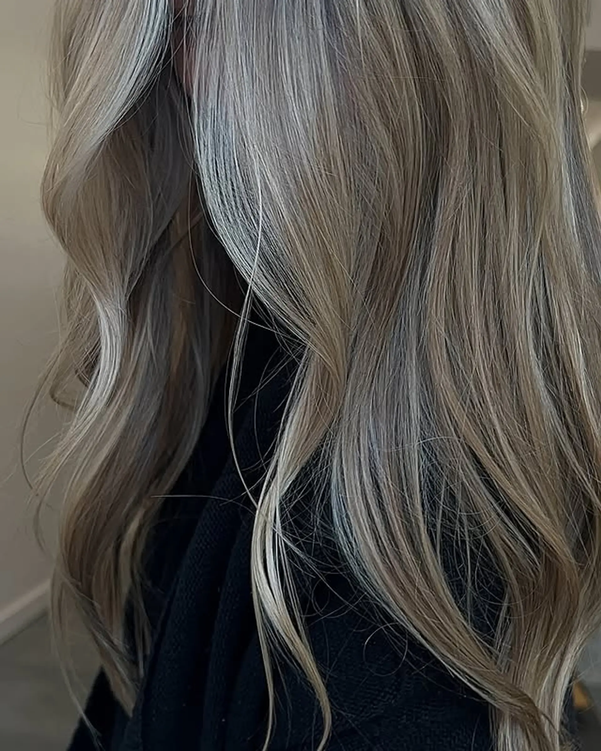 Long, straight hair styled into soft waves with a cool ash blonde tone. 1