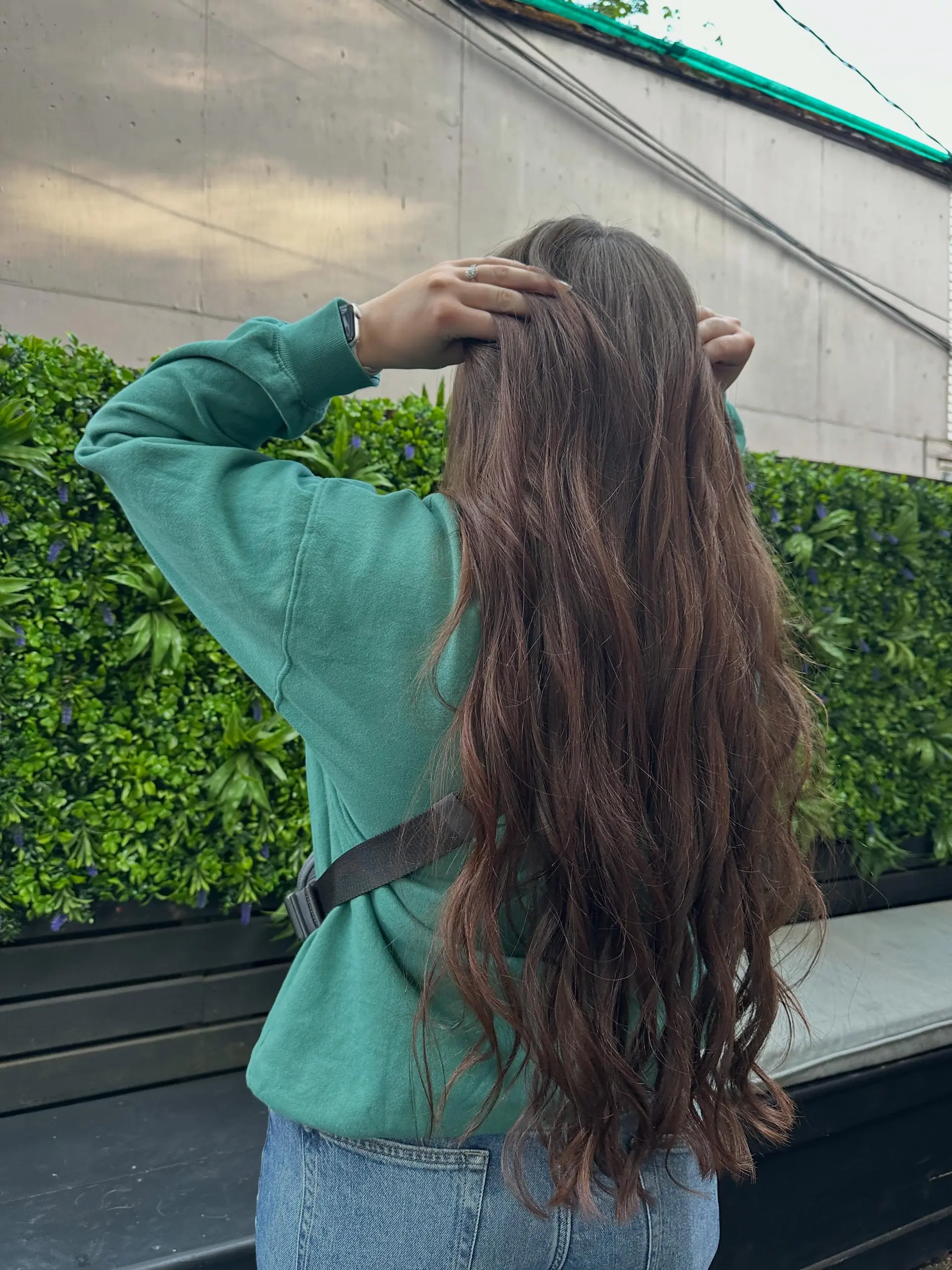 Extra long dark brown hair cut straight across at one length with subtle natural texture. 1