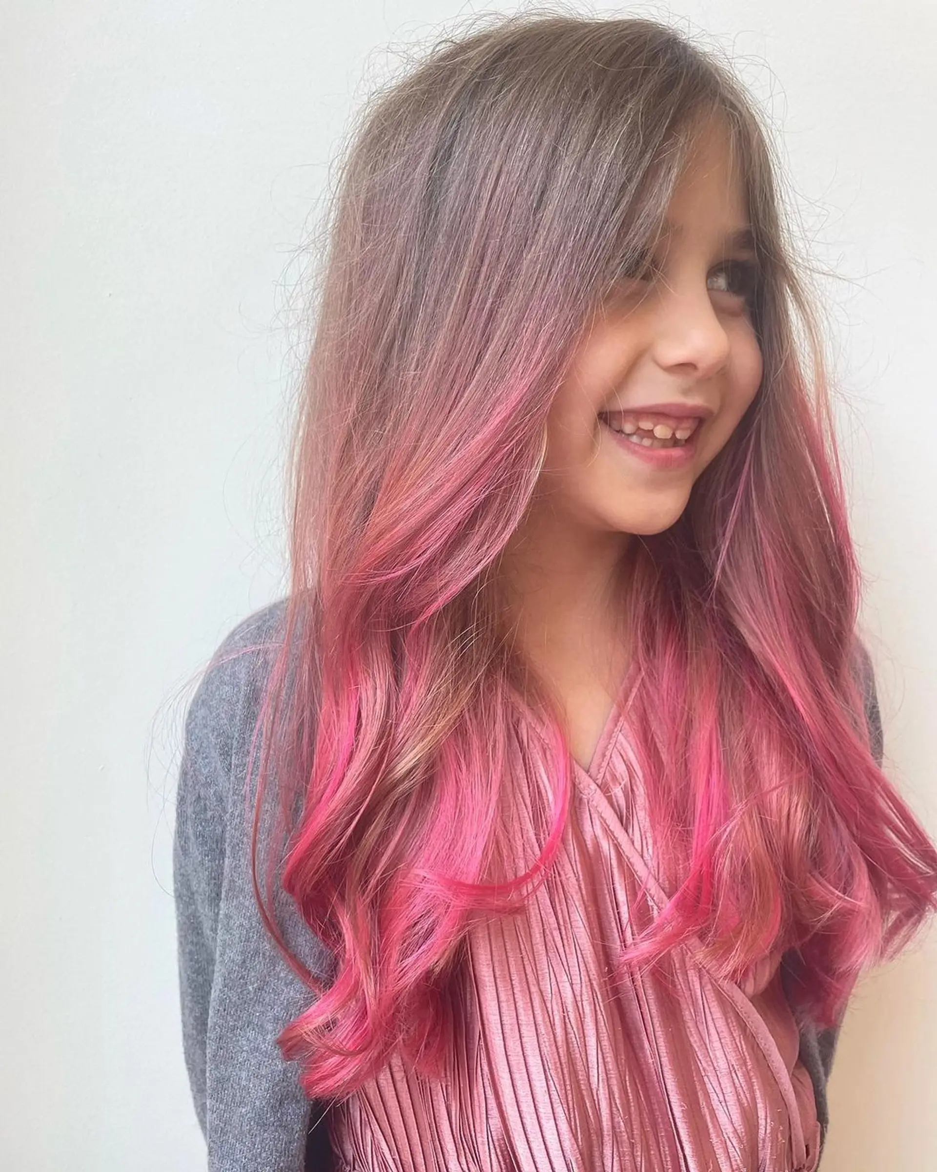 Long wavy hair with playful pink ombre tips, transitioning from natural brown roots. 1