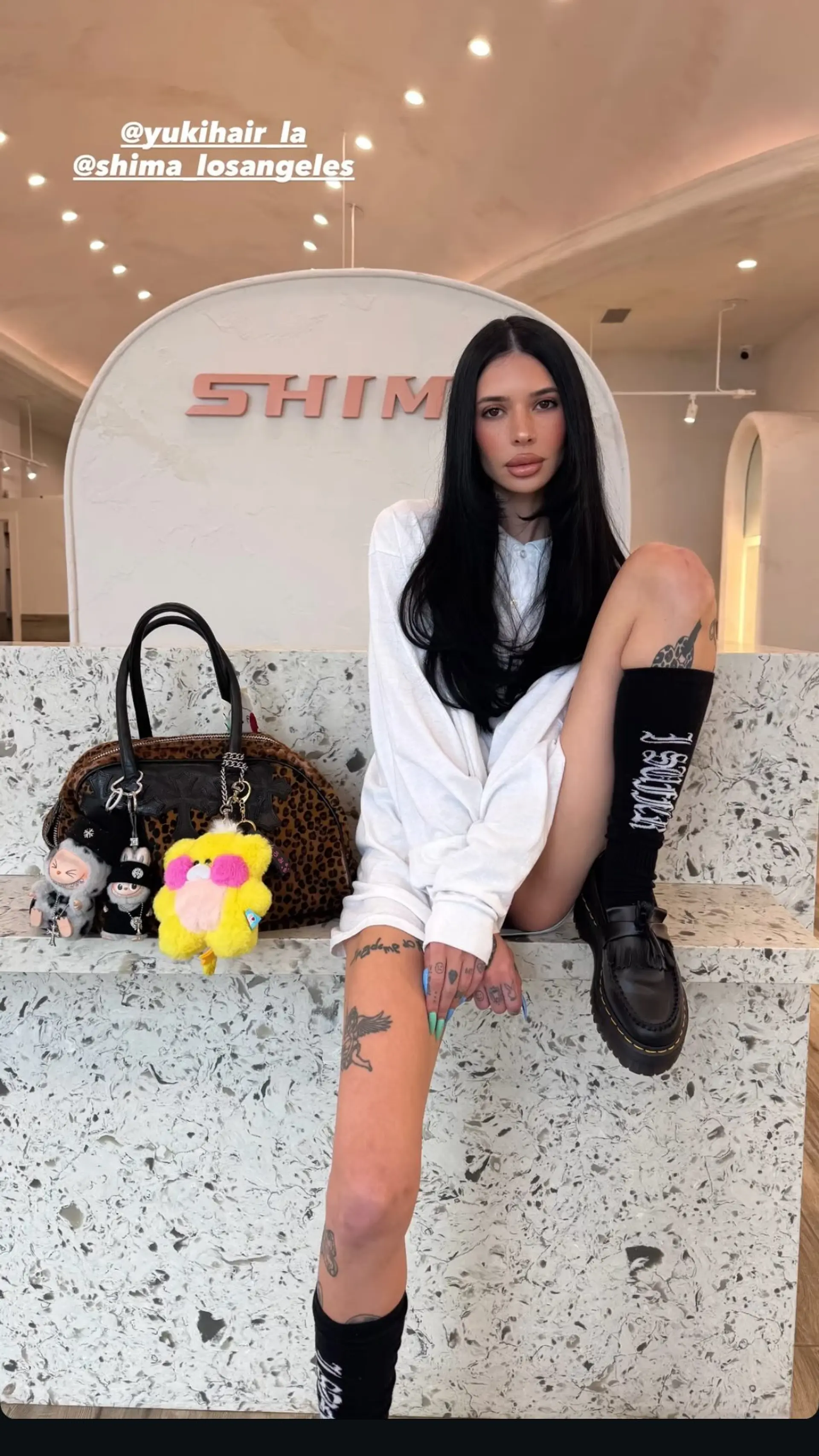 Long jet black hair styled with a center part and soft, face-framing layers. 1