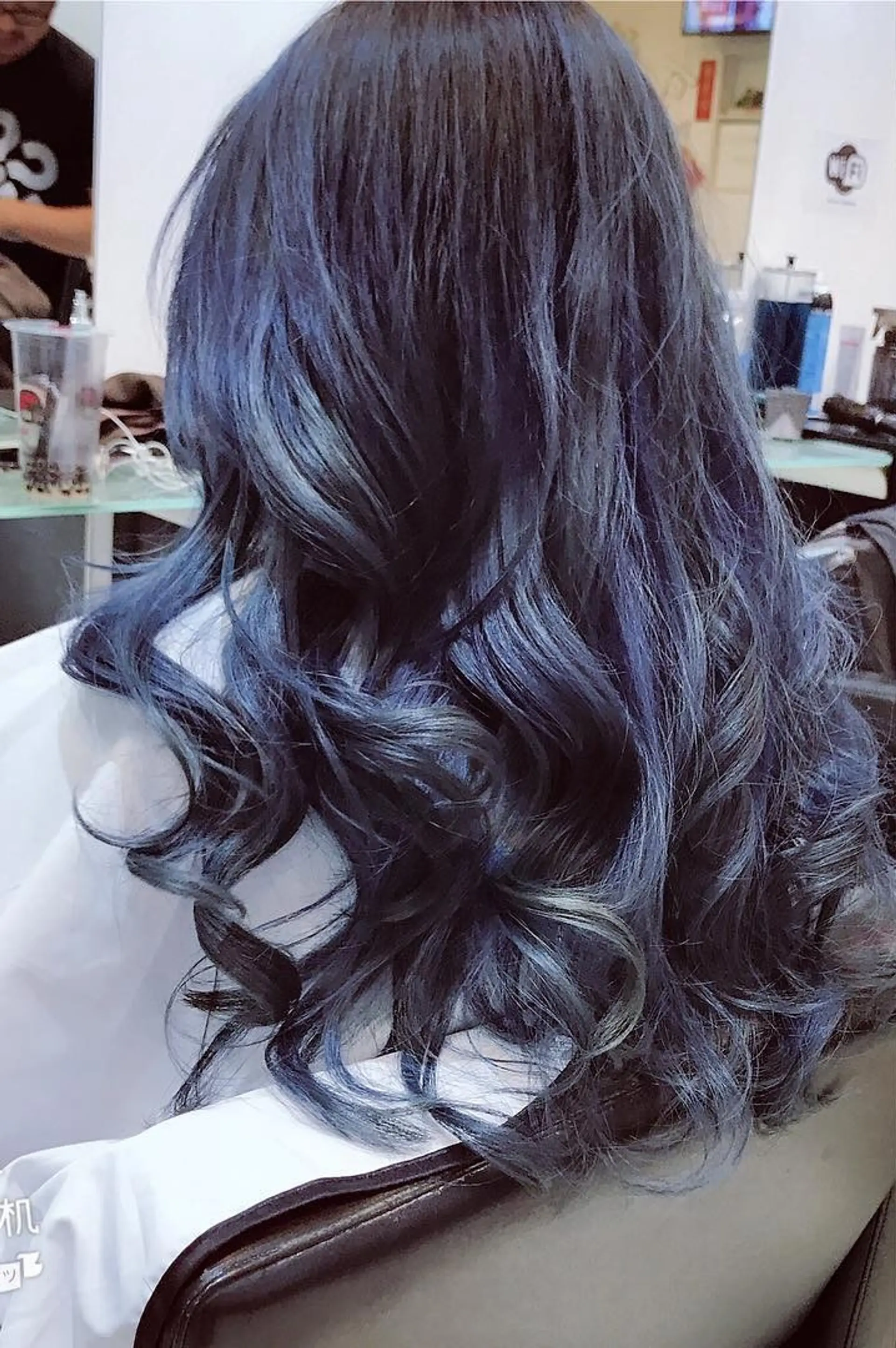 Long, wavy hair with a striking black to blue ombre effect. 1