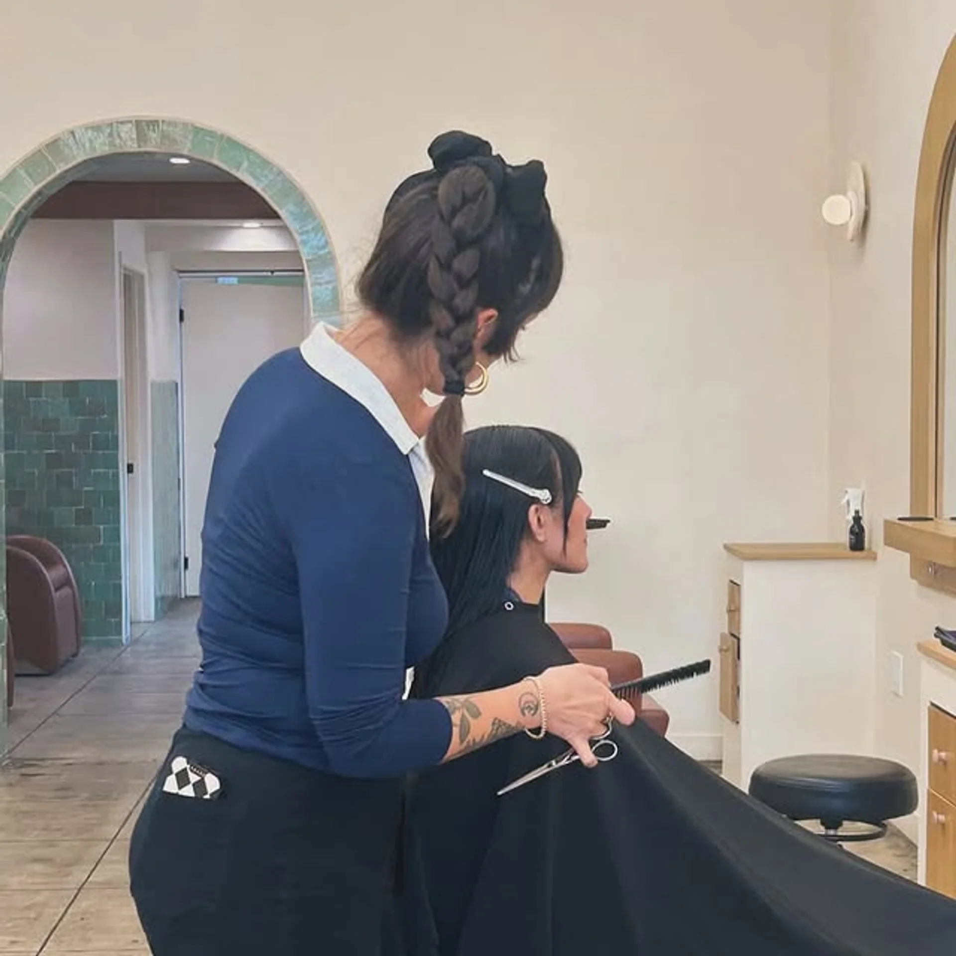 A woman with a chic square bob and elegant curtain bangs, showcasing a modern and sophisticated hairstyle. - Preview 1