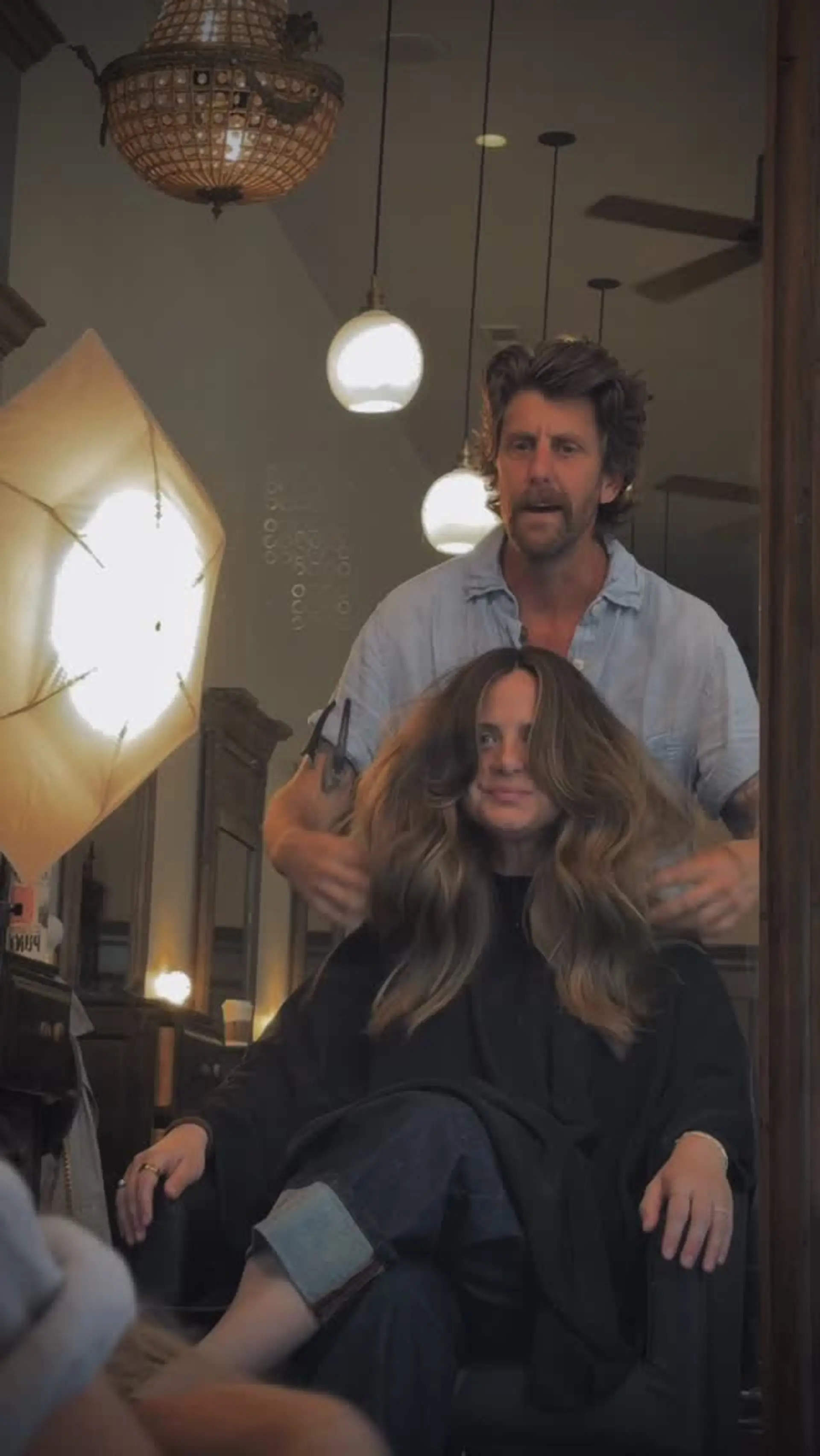 A full, voluminous blowout featuring soft waves, long flowing layers, and sweeping curtain bangs that frame the face. 1