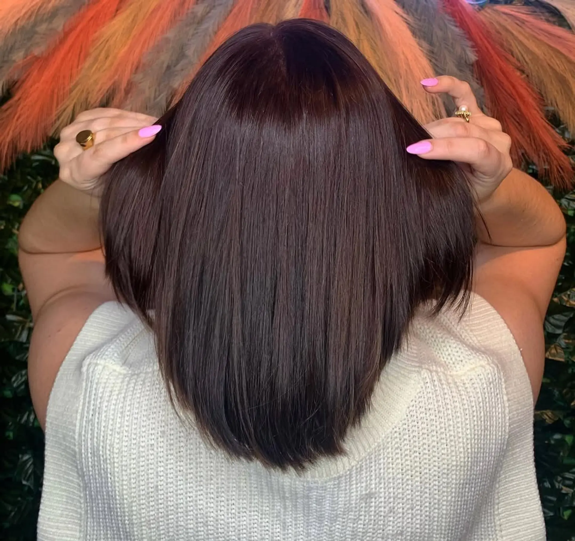 A sharp, sleek angled bob with a blunt cut, featuring a polished and smooth finish that subtly tapers from back to front. 1