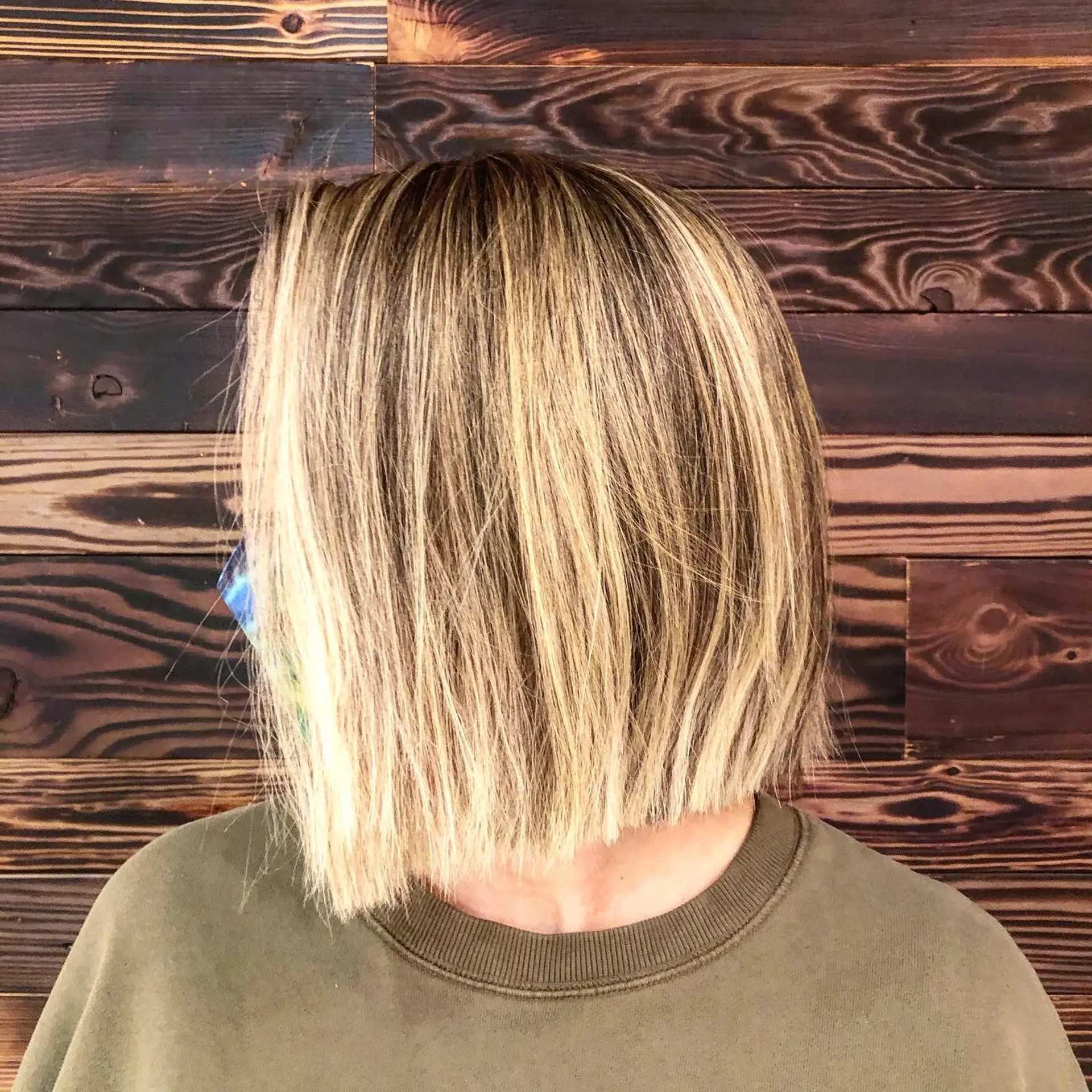 A modern, short, blunt blonde bob with highlights. 1
