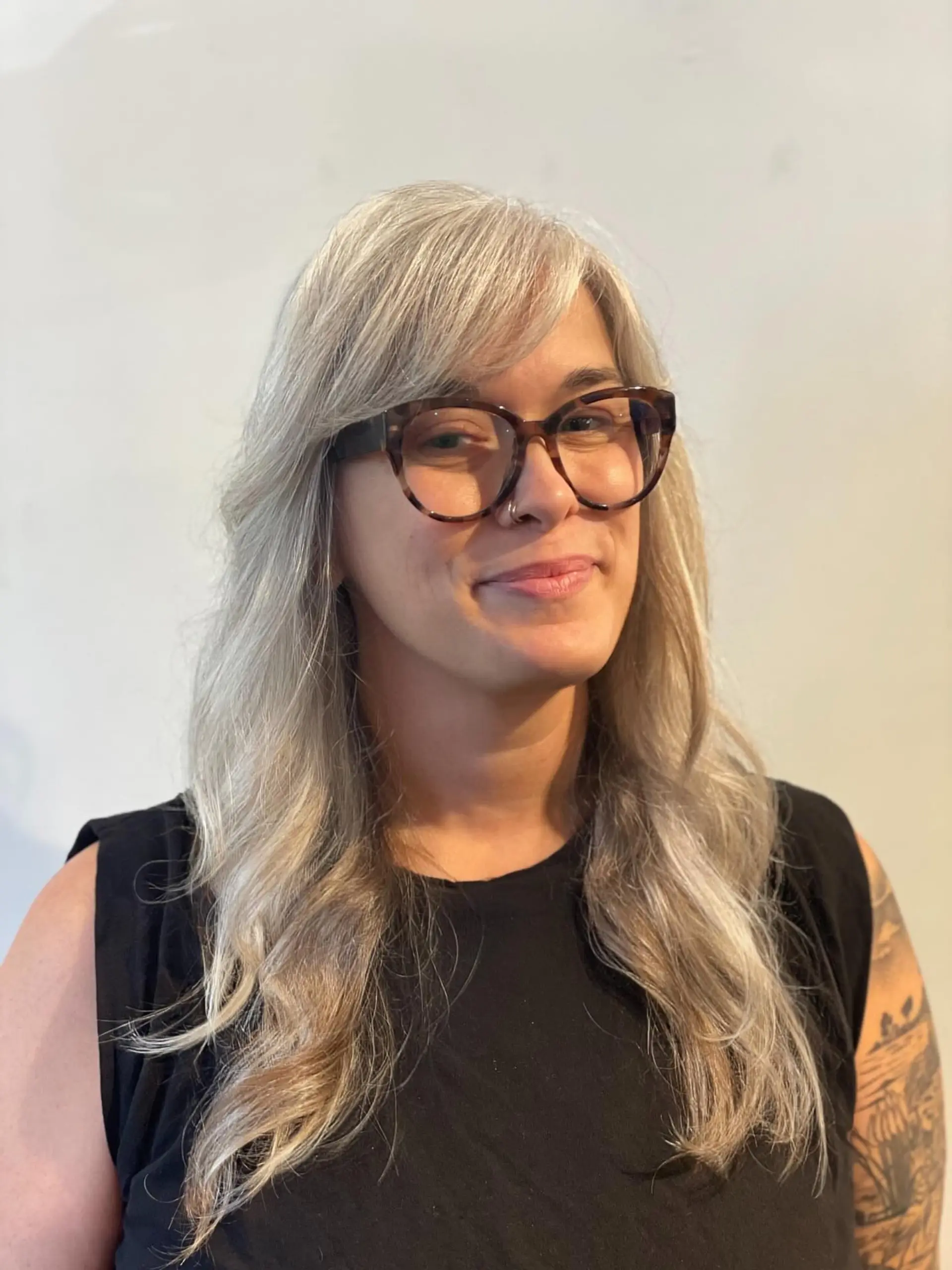 Long layered silver hair styled with soft, natural texture and a side-swept fringe. 1