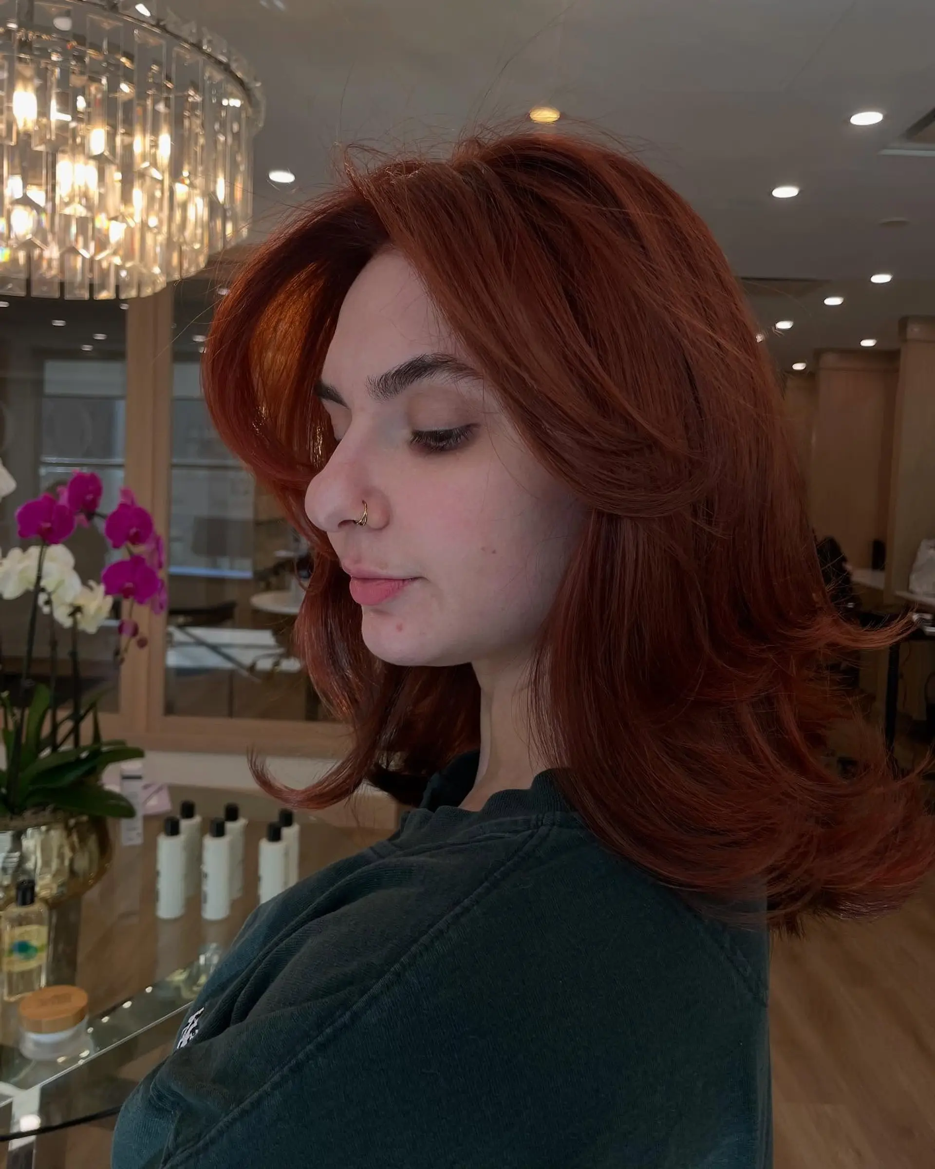 A medium-length layered haircut with face-framing layers and a shaggy texture. 1