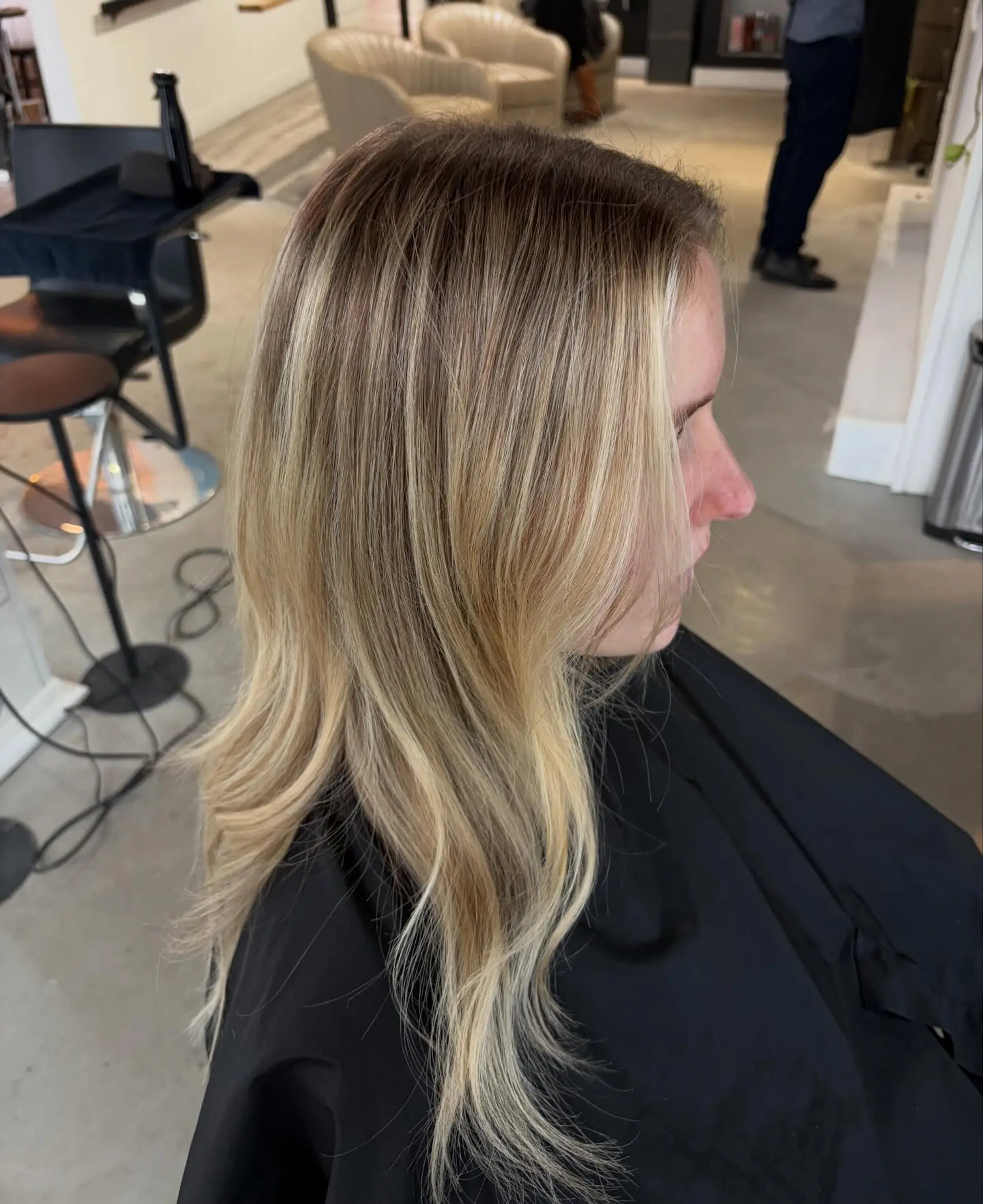 Long dimensional blonde hair featuring soft waves, a blended shadow root, and bright face-framing highlights. 1