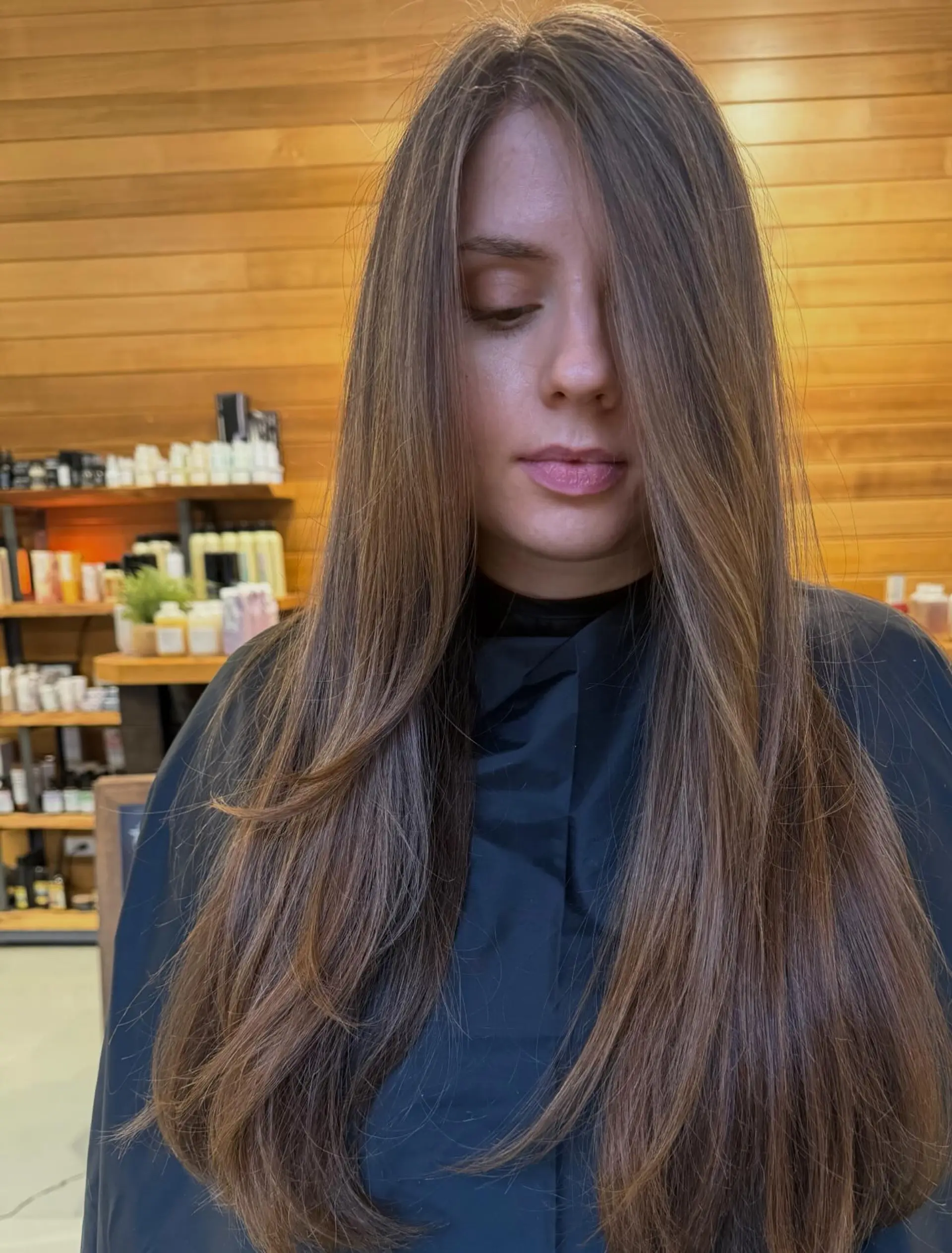 Long straight brunette hair cut with soft face-framing layers and blended subtle highlights. 1