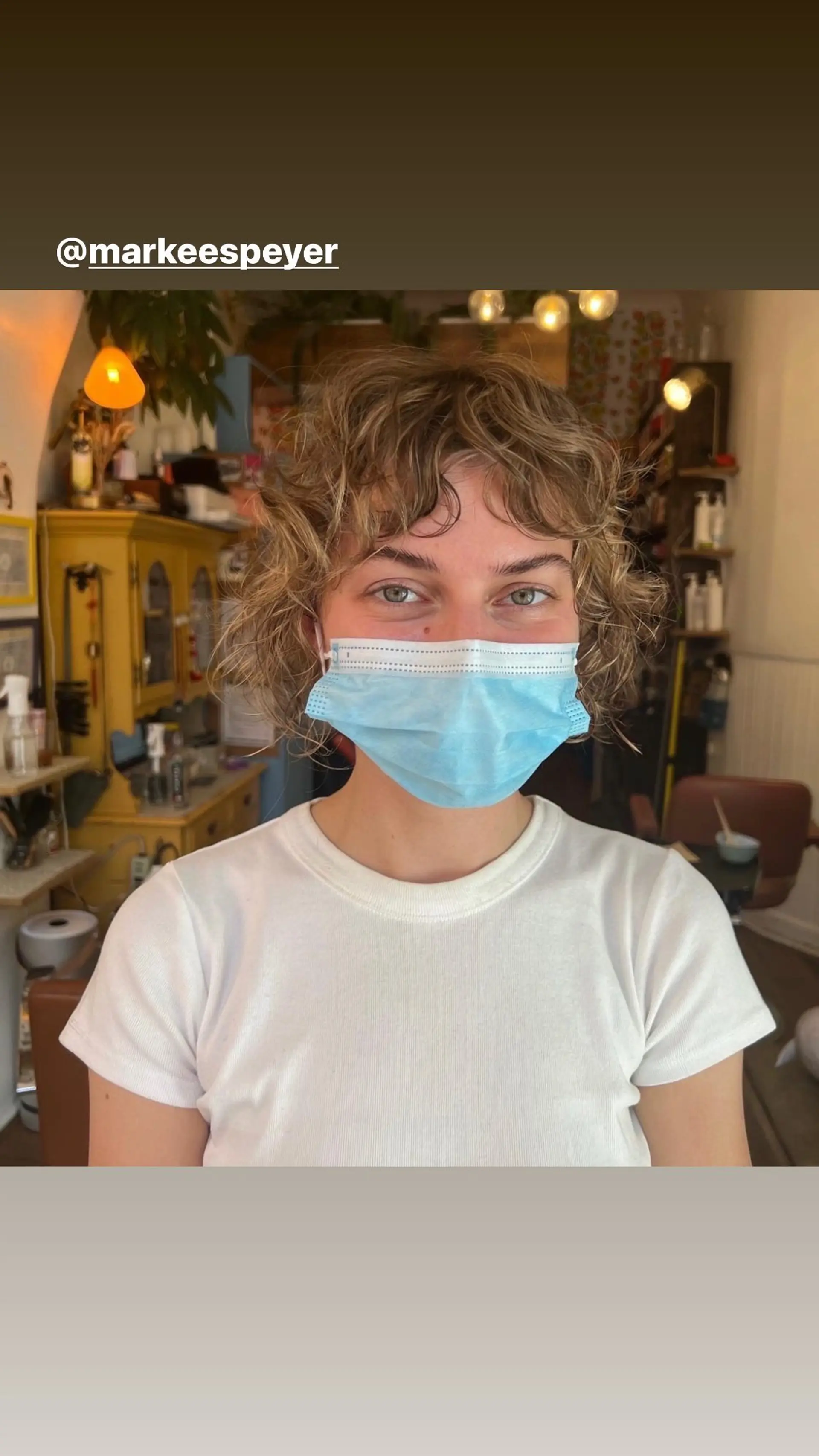 A short, textured curly bob with bangs. 1