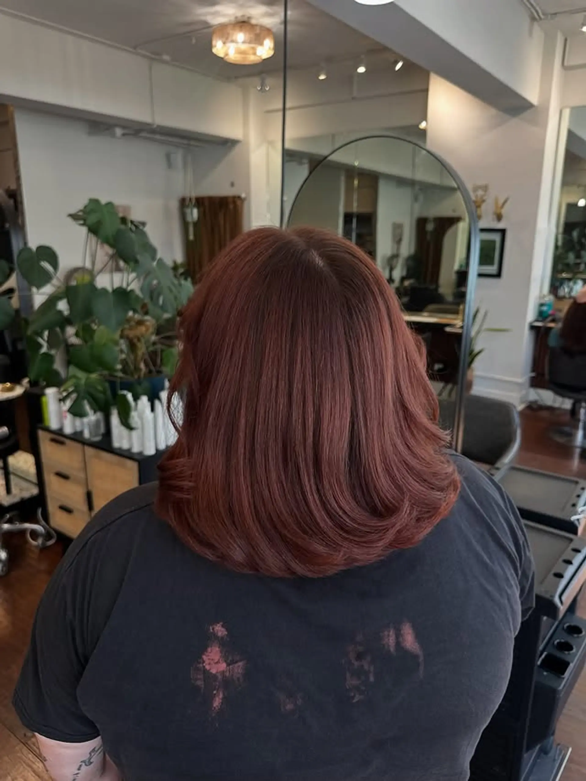 A layered lob haircut with a vibrant copper-red color. 1