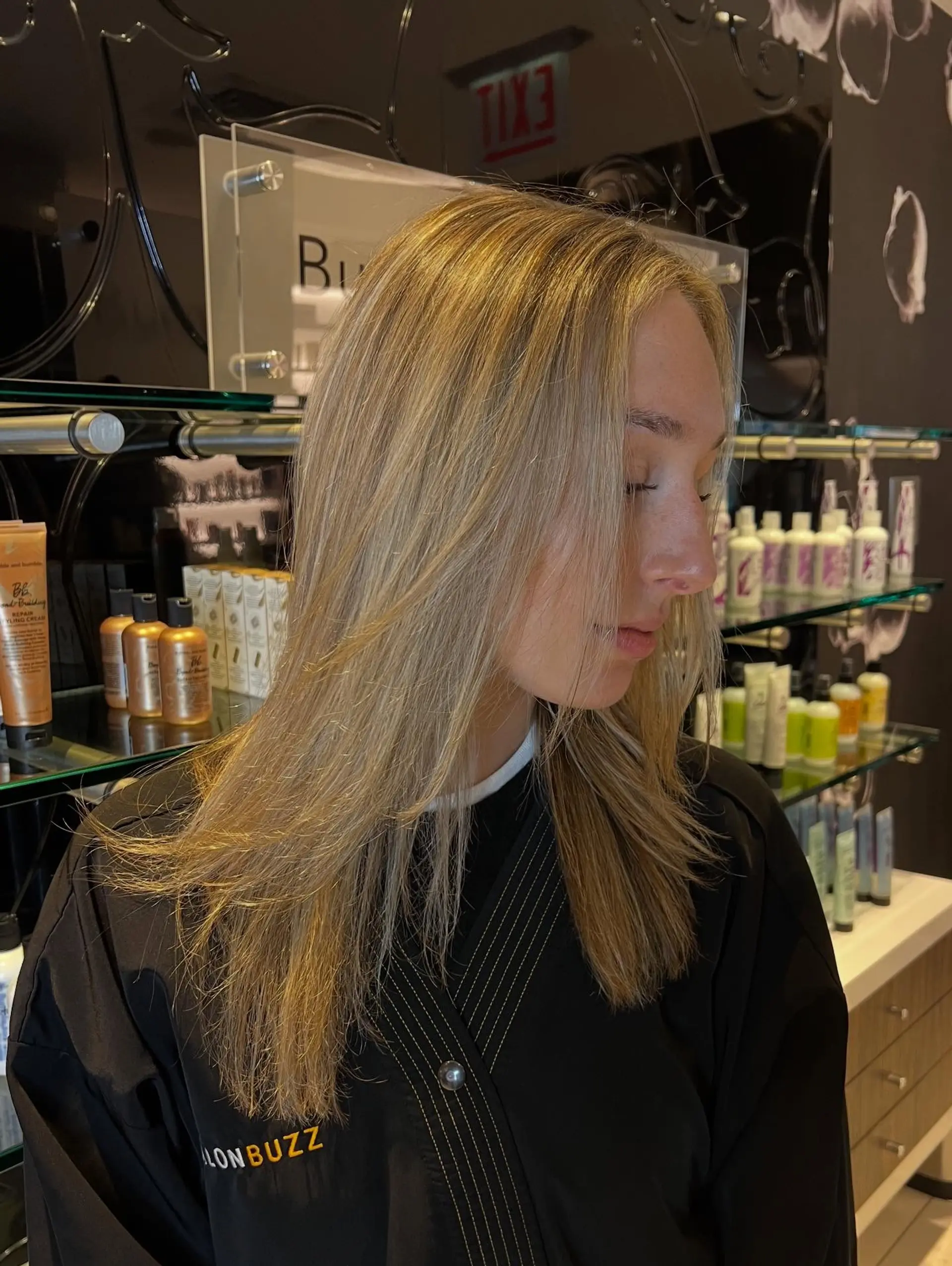 Long, smoothly blown-out hair featuring a soft dimensional blonde balayage with face-framing layers. 1