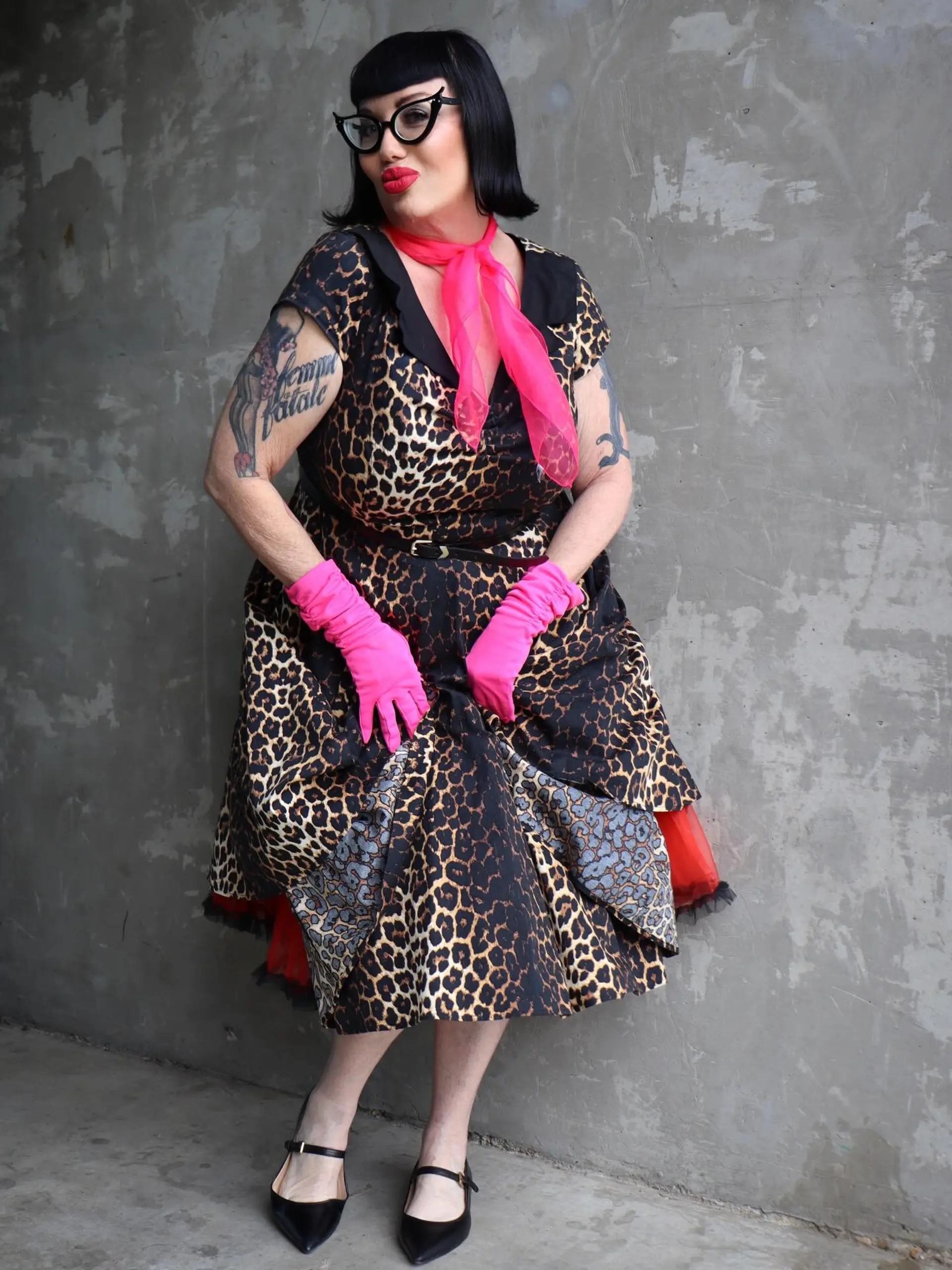A glossy jet-black retro bob featuring blunt, curved Bettie Page bangs and flared ends. 1