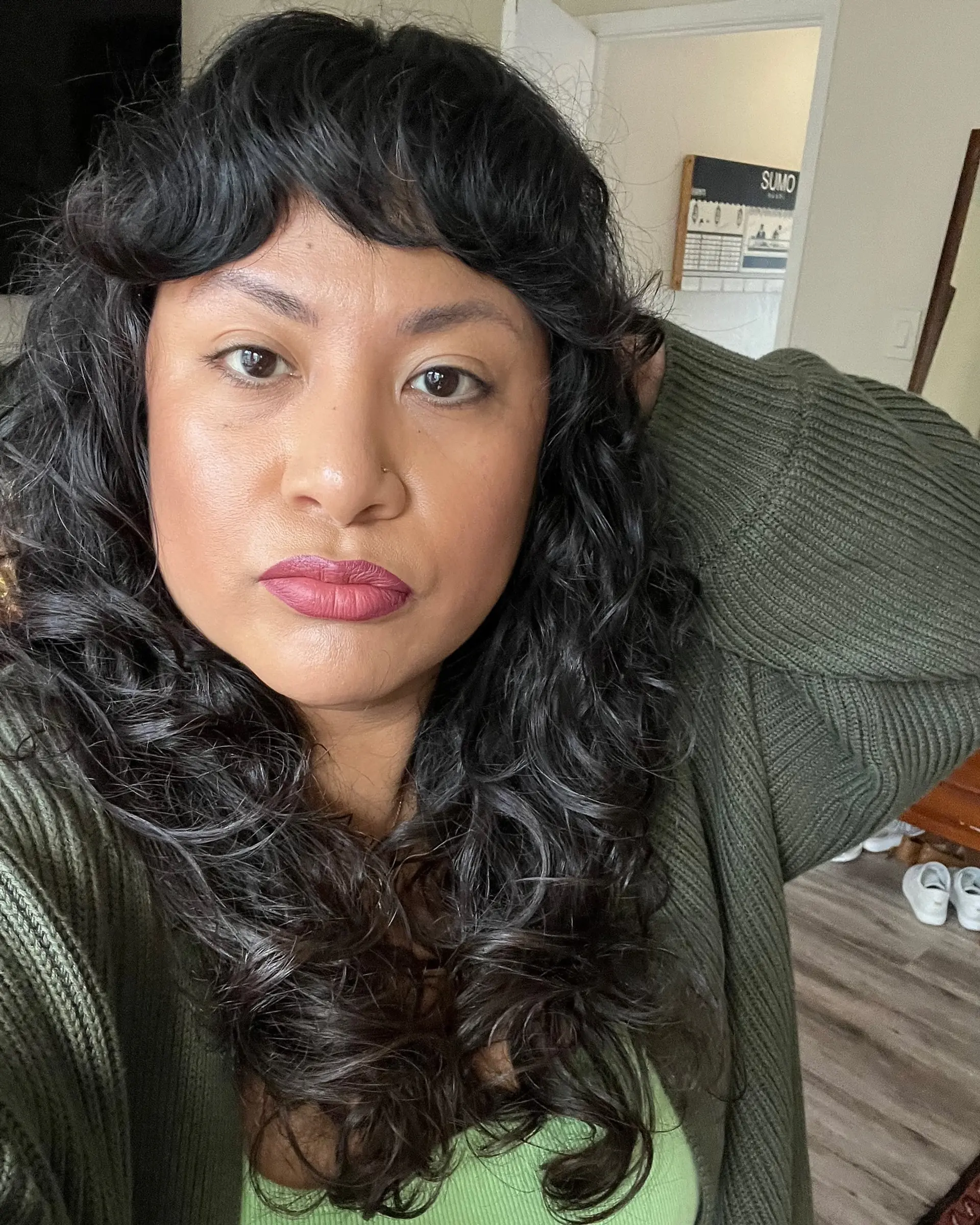A textured curly shag featuring defined ringlets, face-framing layers, and short arched fringe. 1