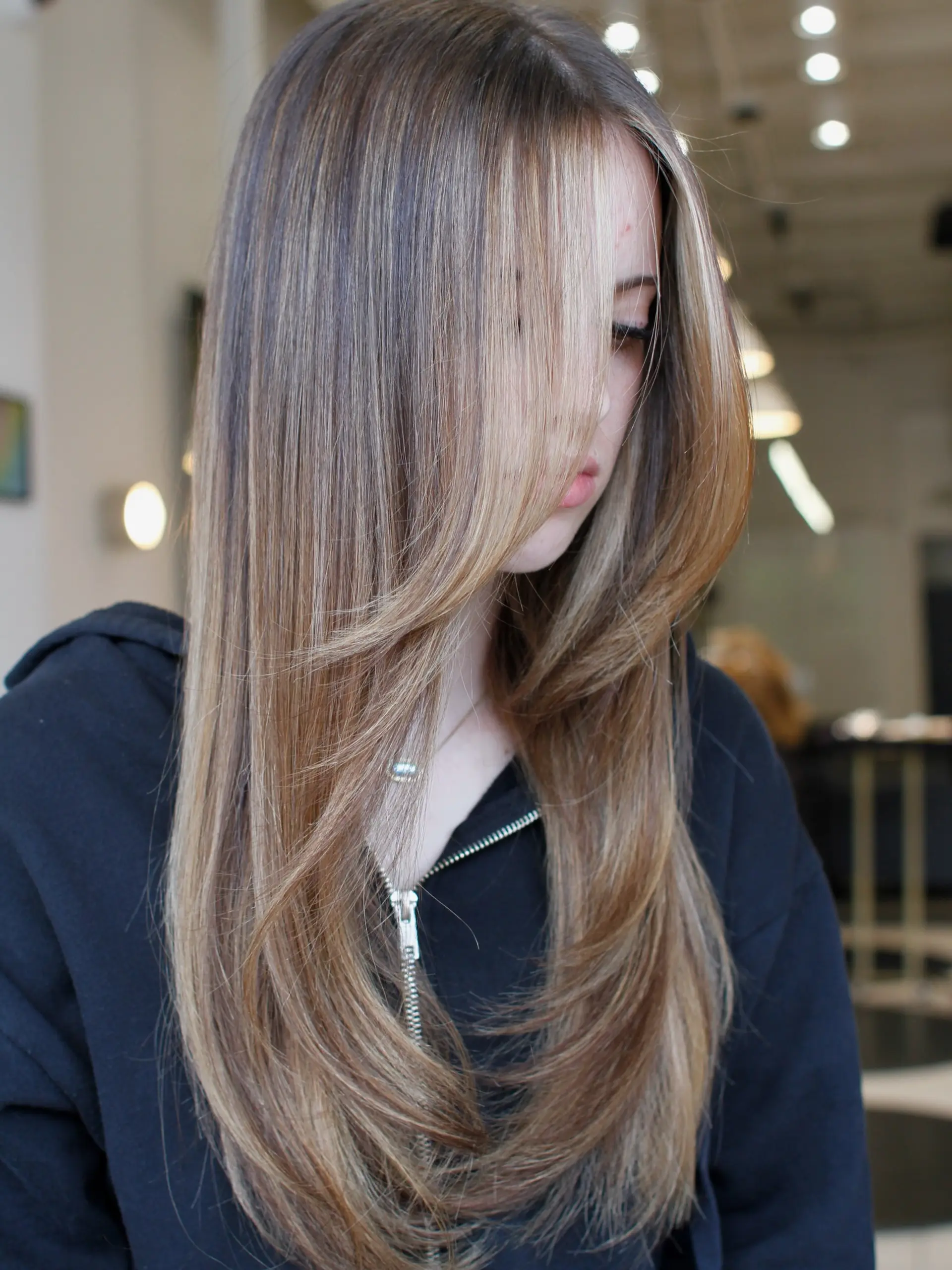 Long straight bright brunette hair featuring soft dimensional highlights and smooth face-framing layers. 1