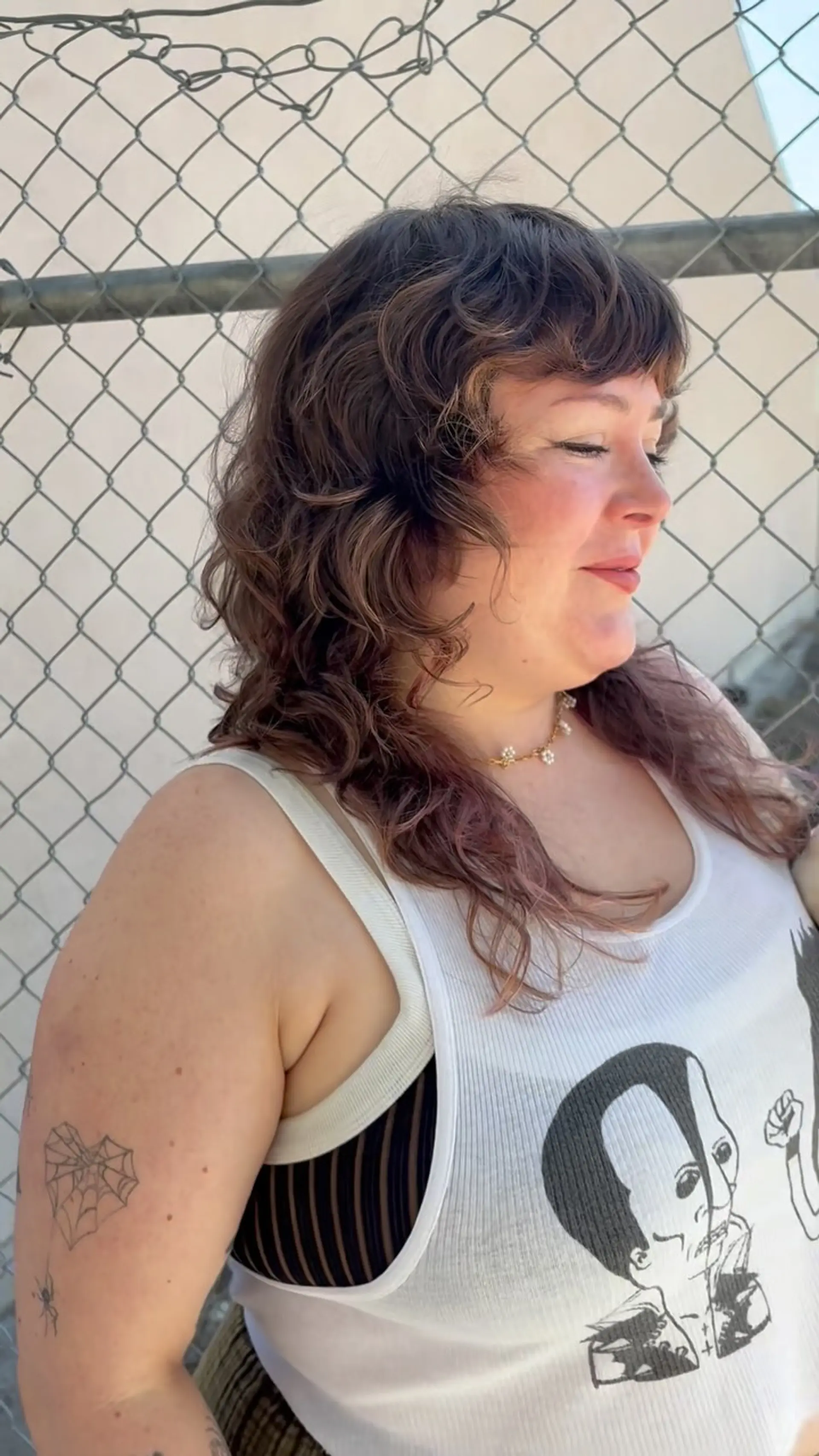 A medium-length curly shag haircut featuring layered texture and soft, face-framing fringe. 1